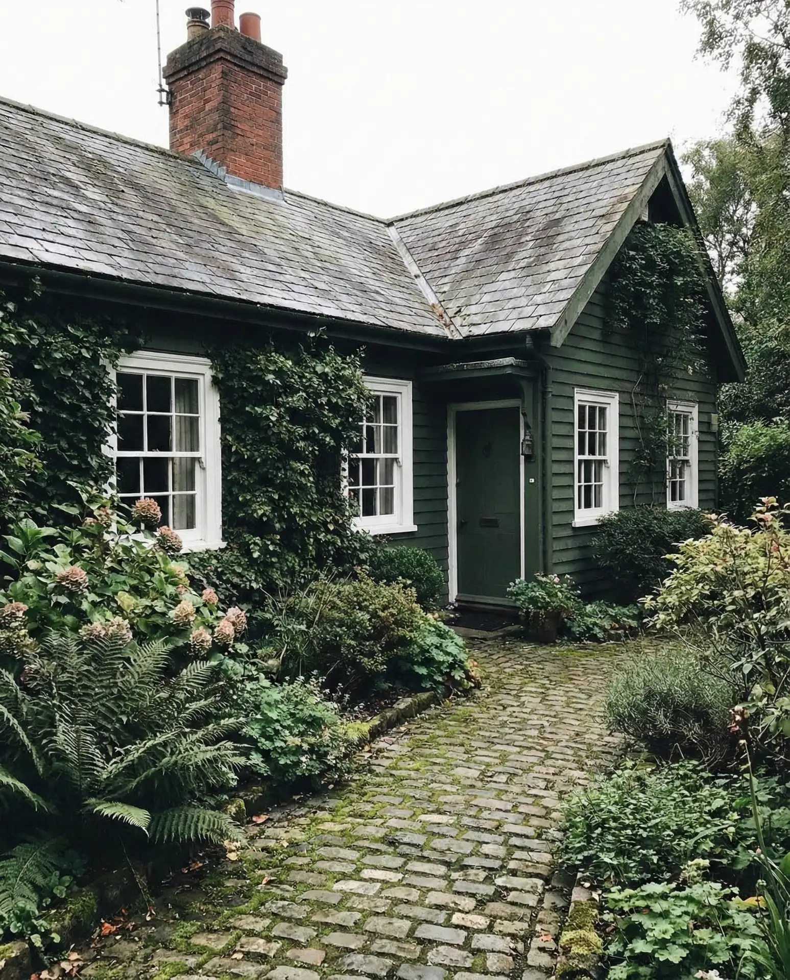 Dark Green Cottage with White Windows and Brick Accents 1