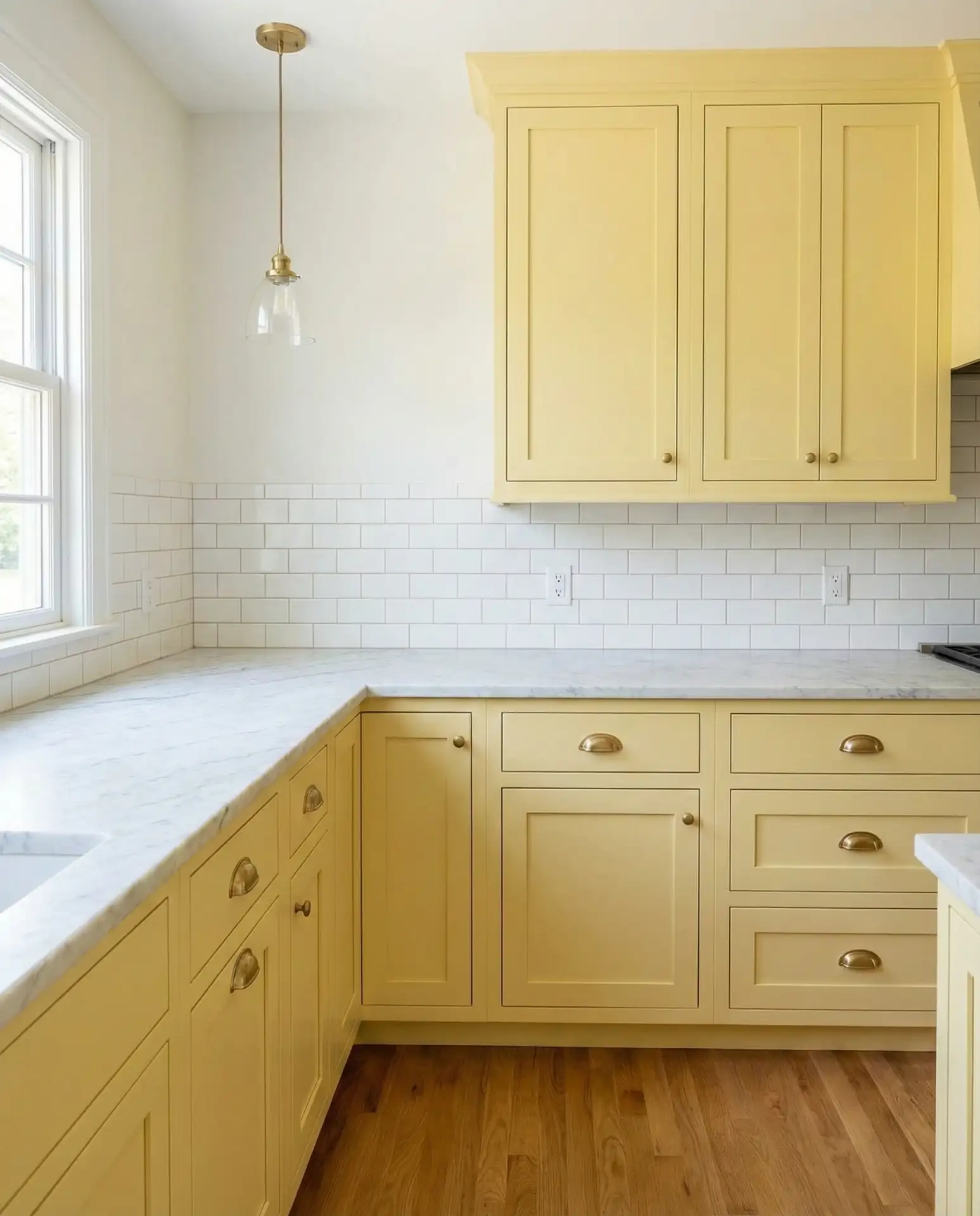Pale Yellow Shaker Cabinets with Brass Hardware 1