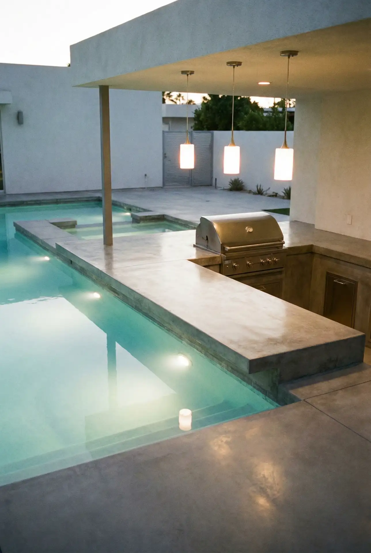 Modern Pool-Side Kitchen with Sleek Concrete Finishes 1