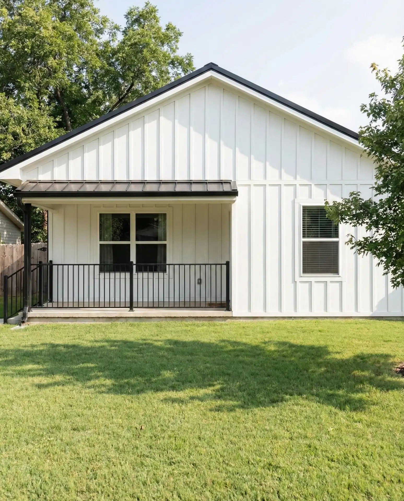 White Vertical Siding with Black Metal Details 2