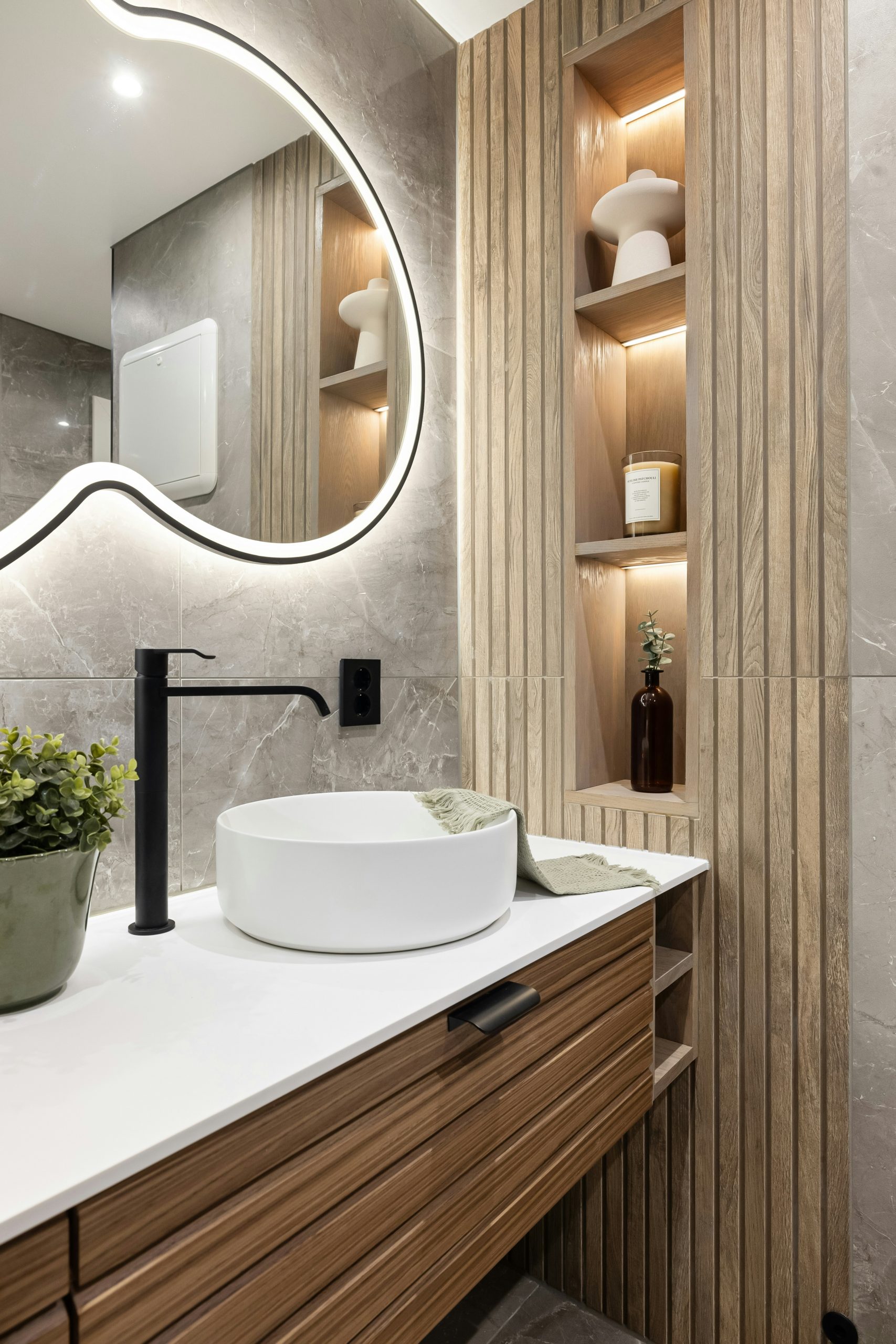 A bathroom with a sink and a large mirror