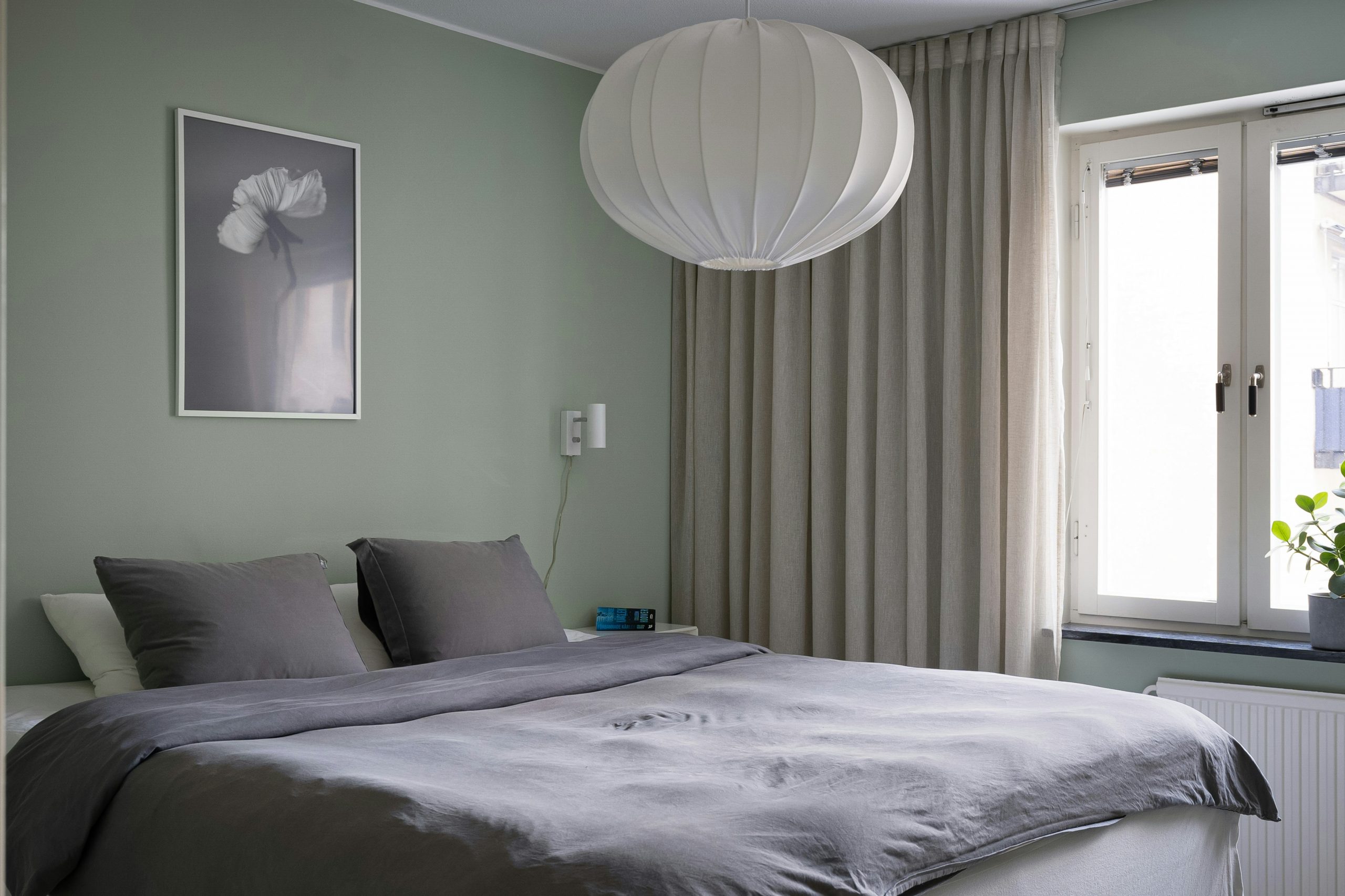 A bedroom with a large bed and a large window