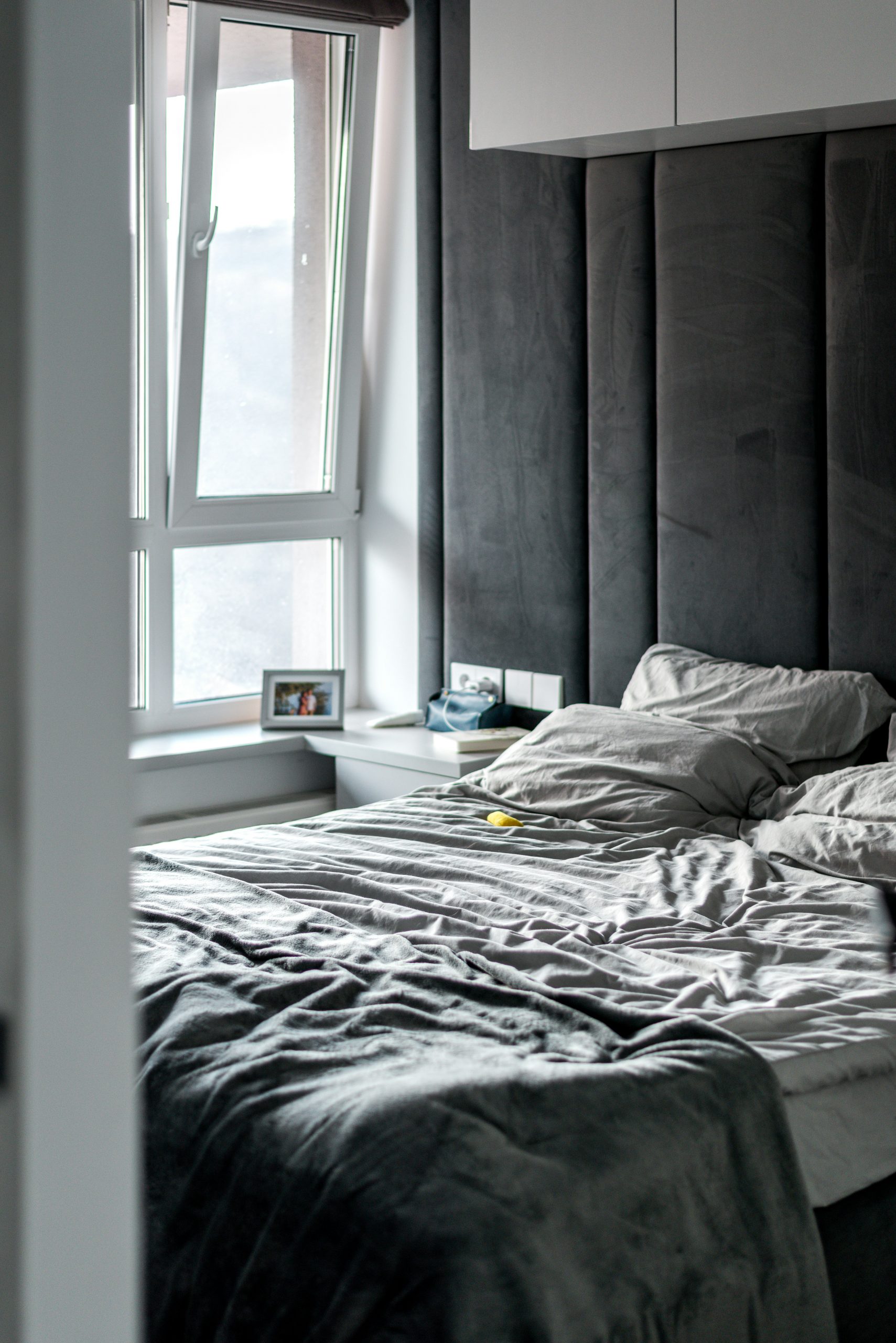 a bedroom with a large bed and a window
