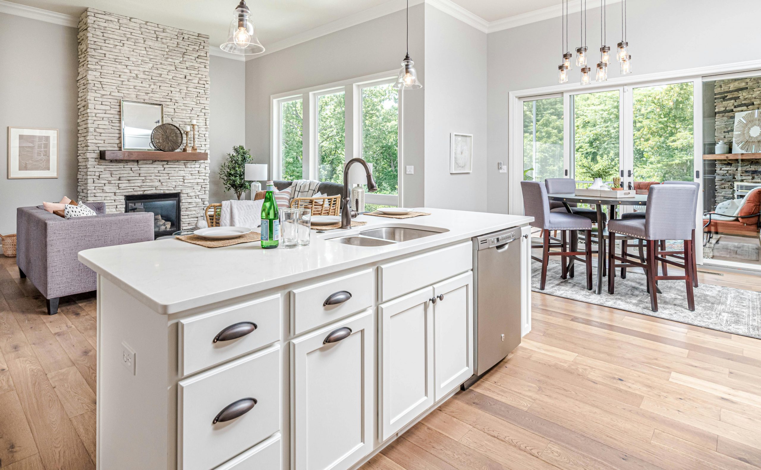 A bright modern kitchen features a stylish white island and spacious dining area.