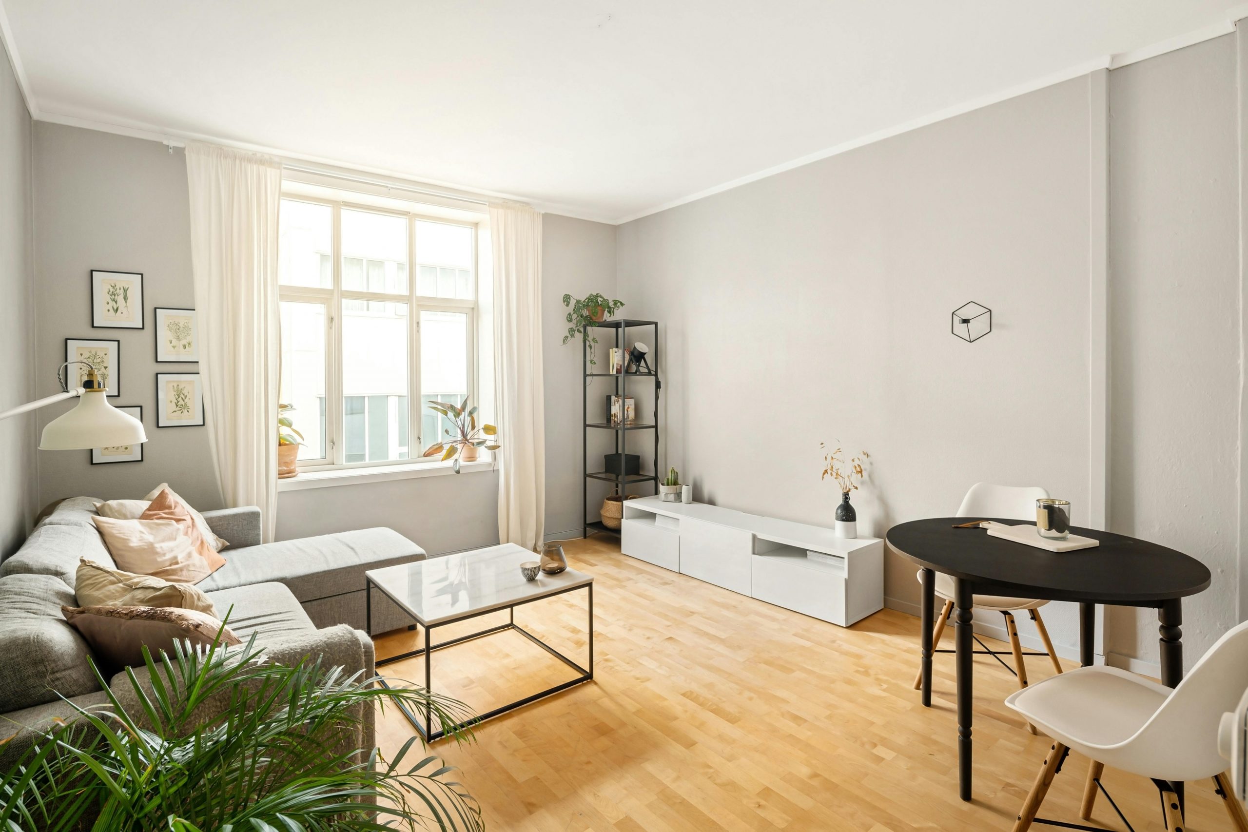 A contemporary Scandinavian living room with minimalist furniture and decor.