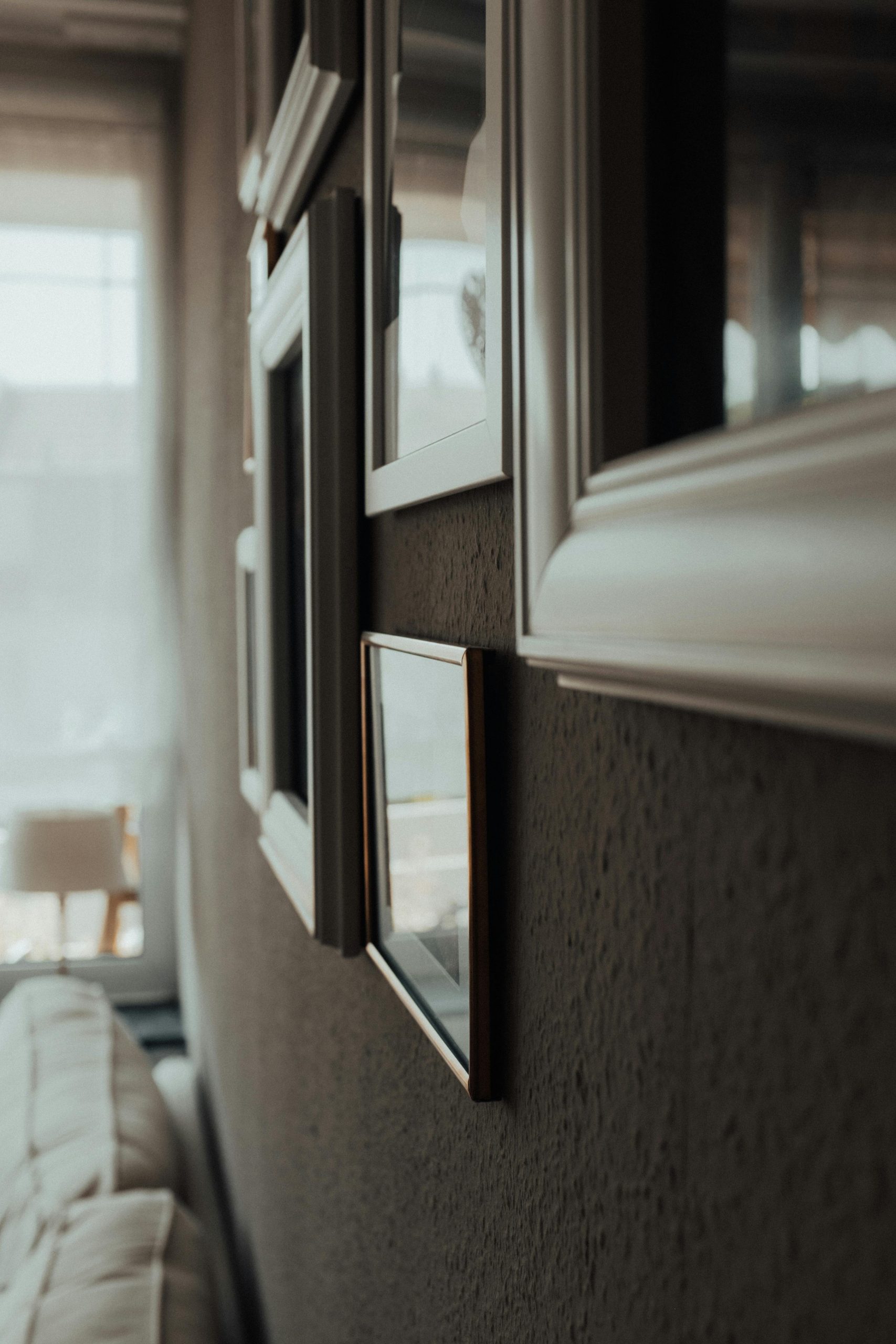 A cozy interior with a gallery wall of framed pictures and soft ambient lighting.