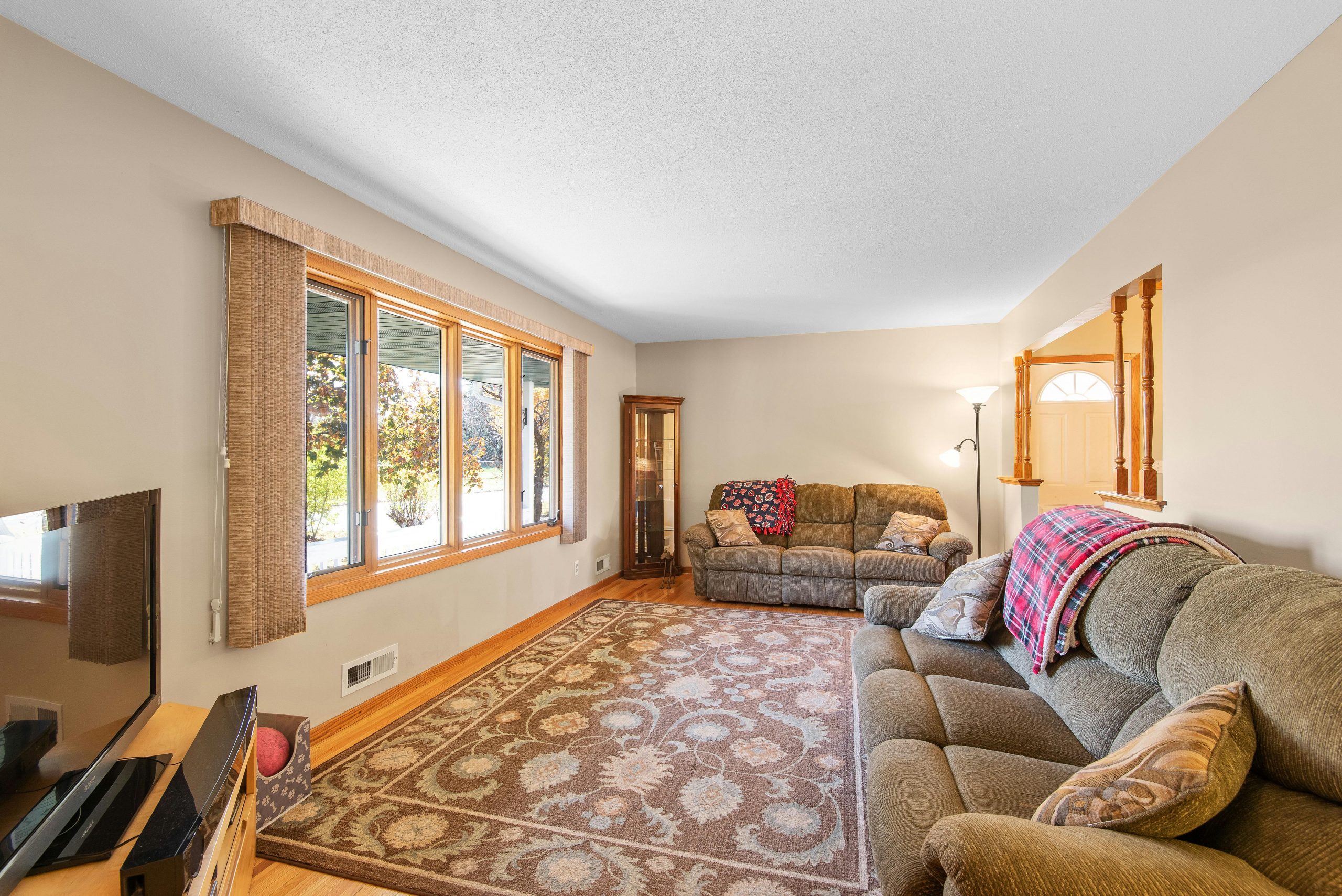 Bright and inviting living room featuring cozy sofas and large windows.