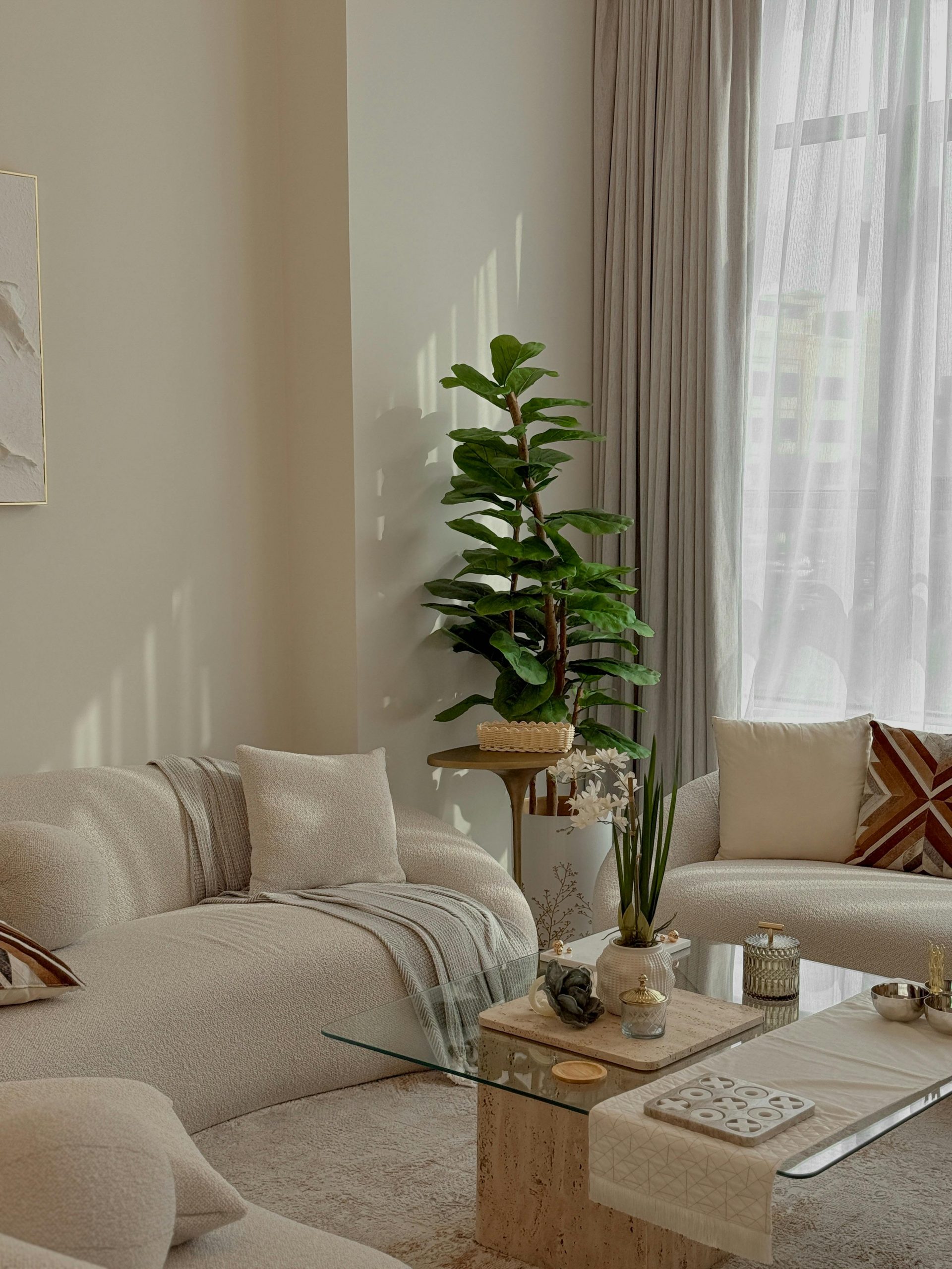 Cozy minimalist living room with natural light and plant decor in Dubai.
