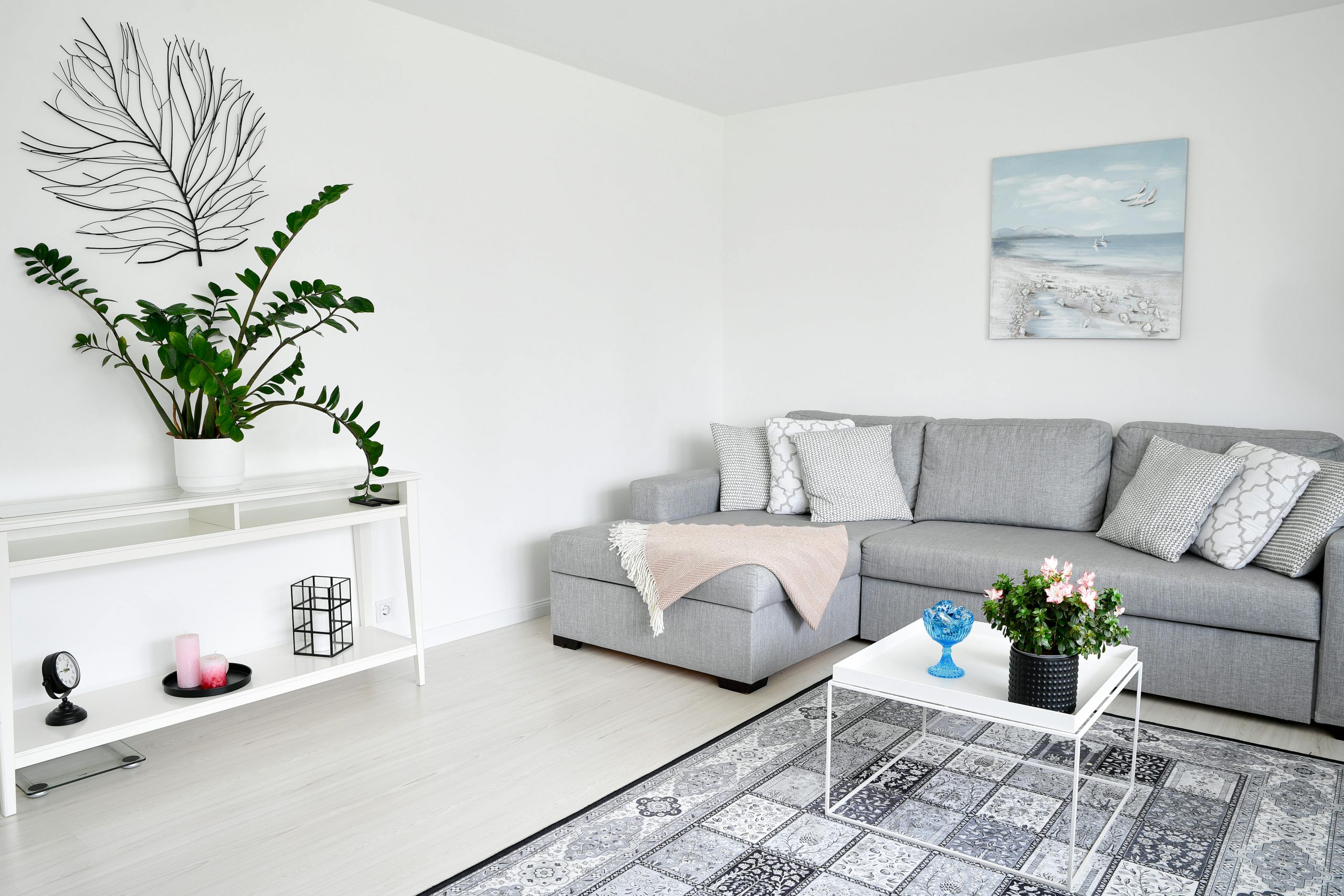 Stylish Scandinavian living room in Espoo, Finland, featuring a grey sofa, houseplants, and minimalist decor.