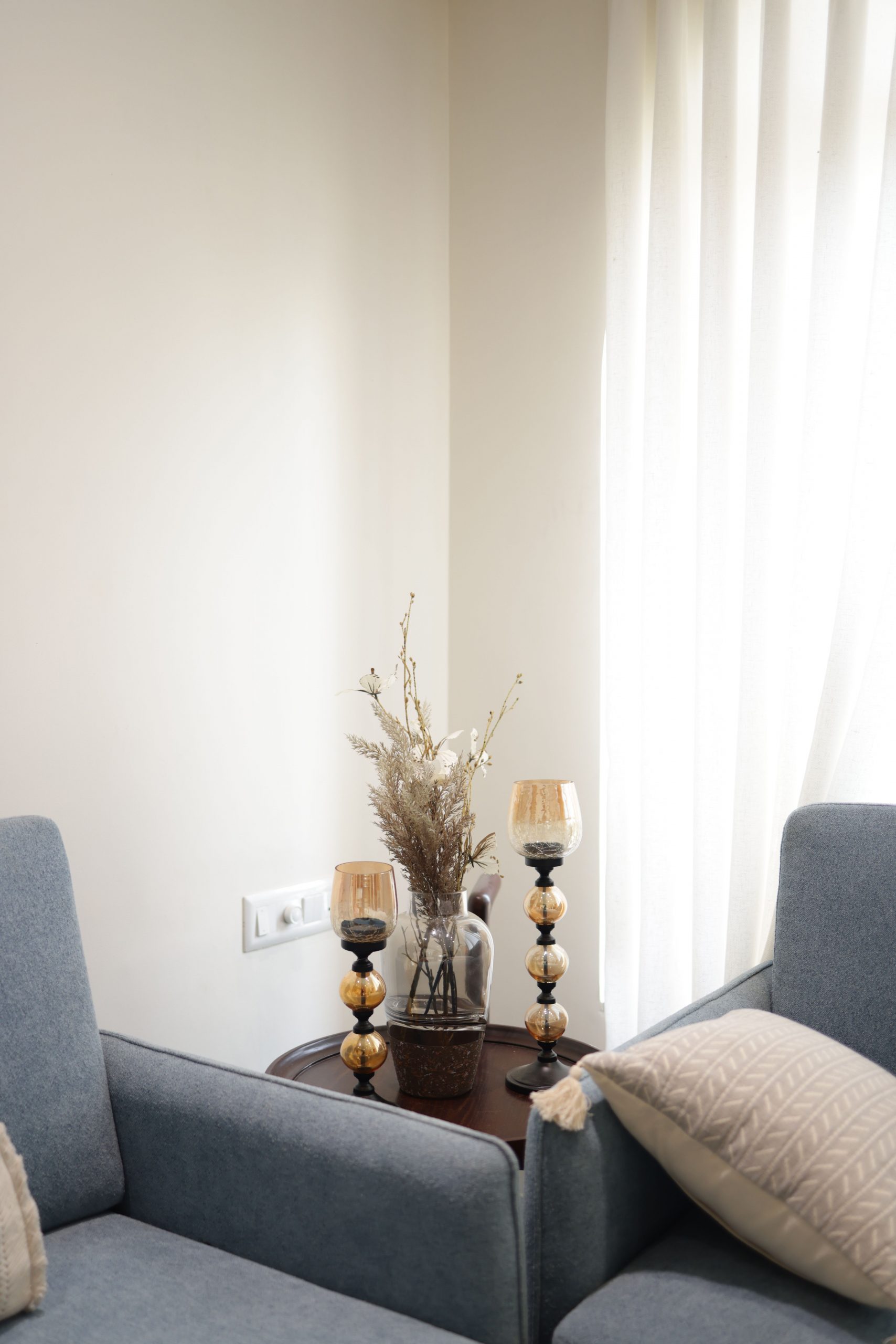 A cozy minimalist corner with elegant decor, featuring soft lighting and modern furnishings.
