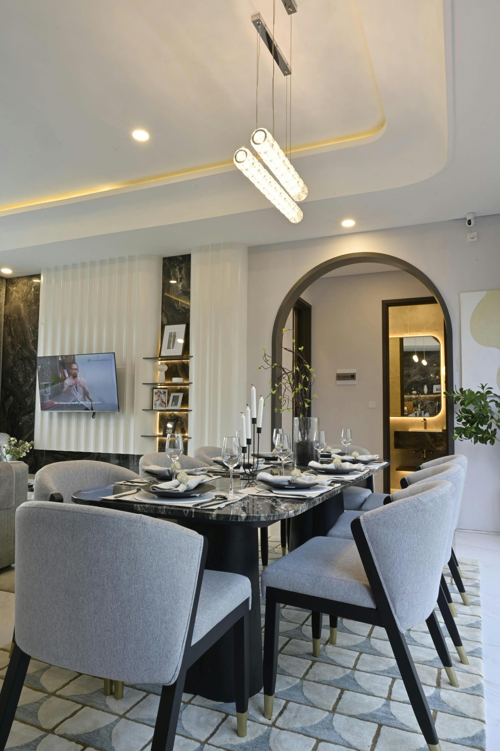 A sophisticated dining room featuring modern furniture, unique lighting, and tasteful decor.