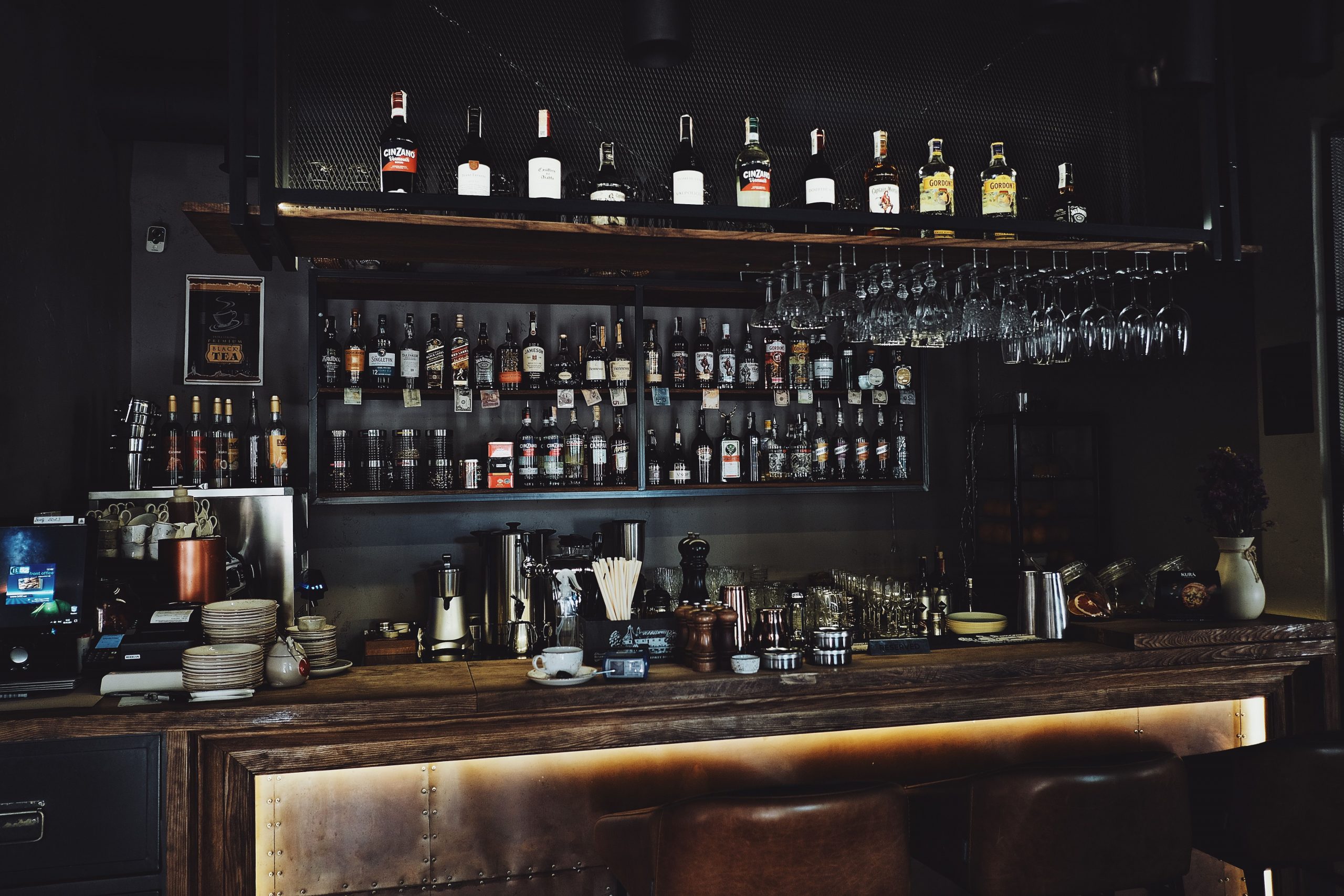 A stylish bar interior showcasing a variety of spirits and glasses.