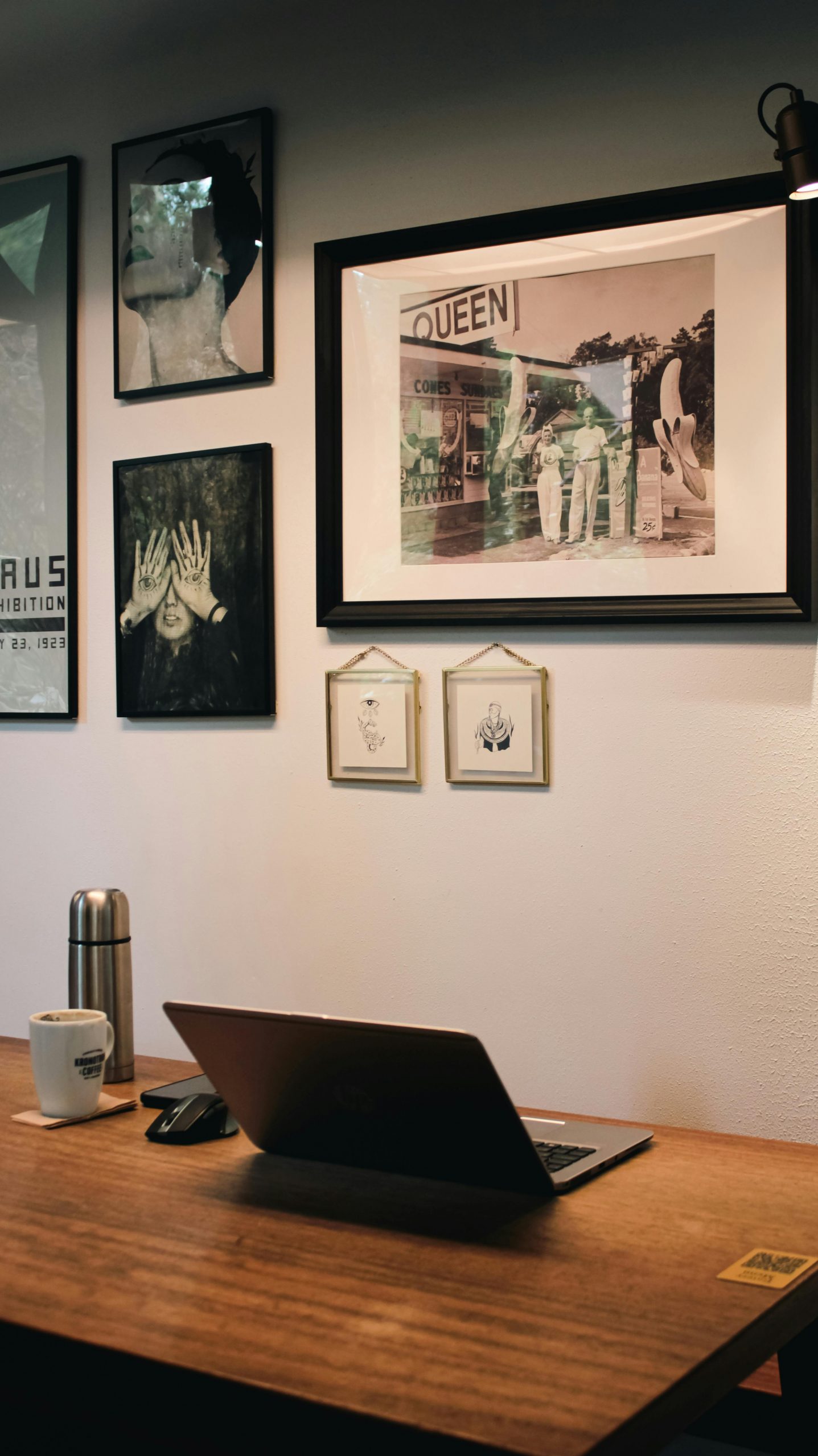 A stylish home office with a laptop, art decor, and a warm ambiance.