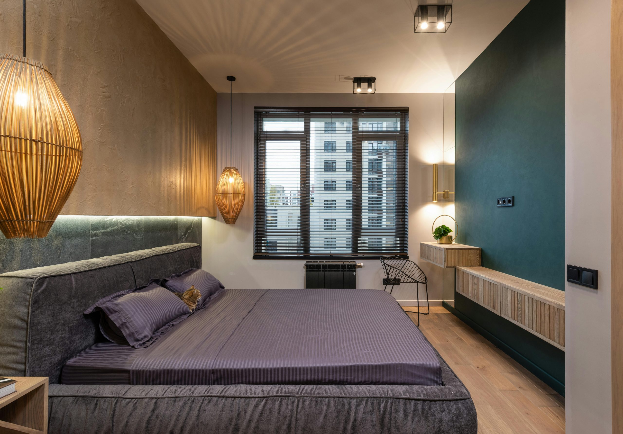 A stylish modern bedroom featuring luxurious decor, ambient lighting, and a city view through the window.