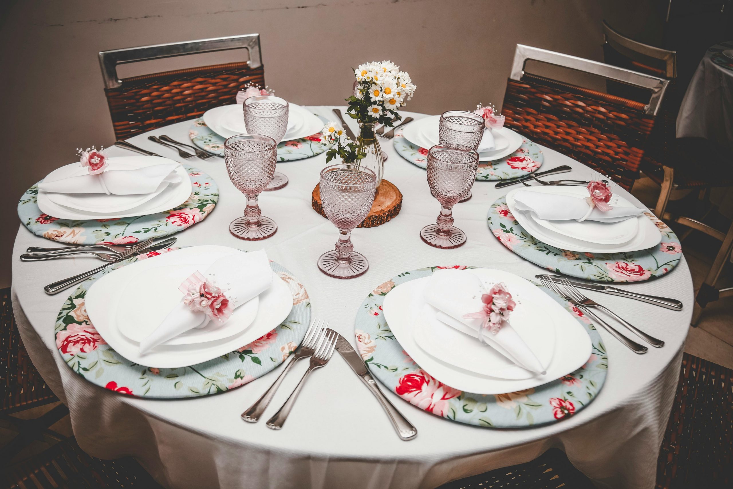 Beautifully arranged dining table with floral decor and elegant flatware for a special occasion.