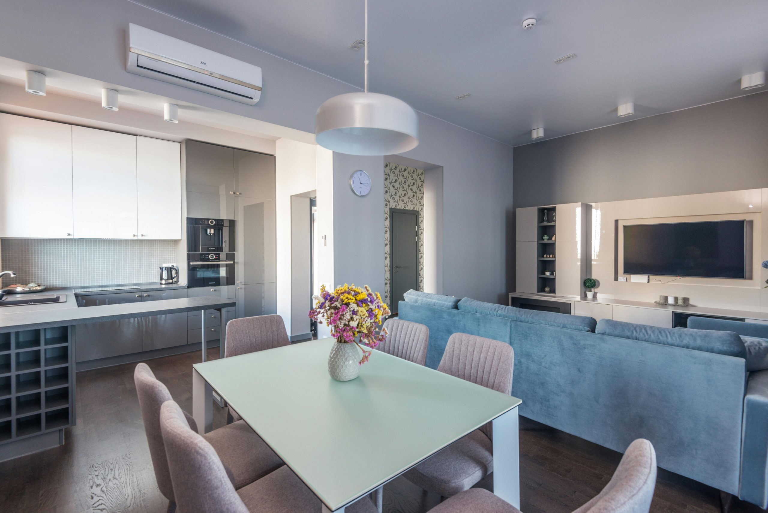 Bright and modern open living room and kitchen with stylish furniture.