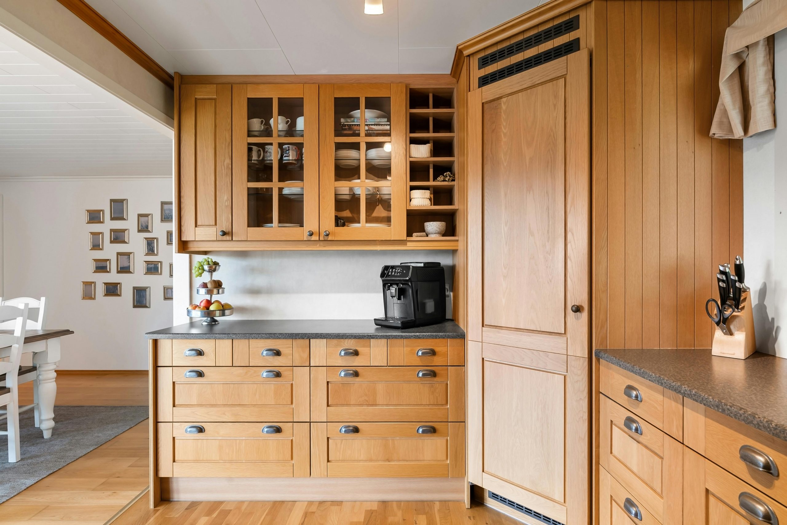 Elegant kitchen interior showcasing oak wood cabinets and modern appliances.