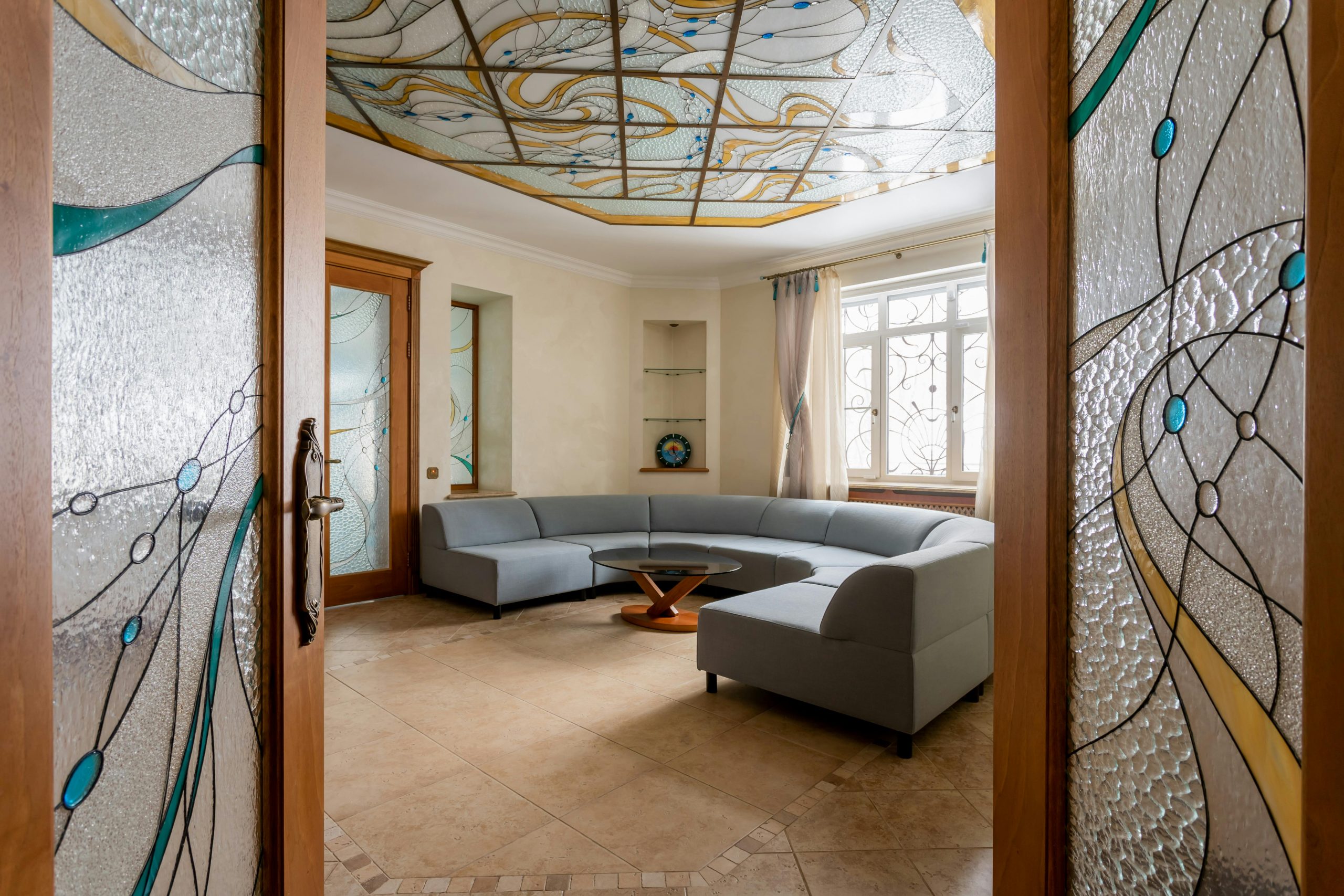 Elegant living room featuring a stained glass ceiling and modern interior design.