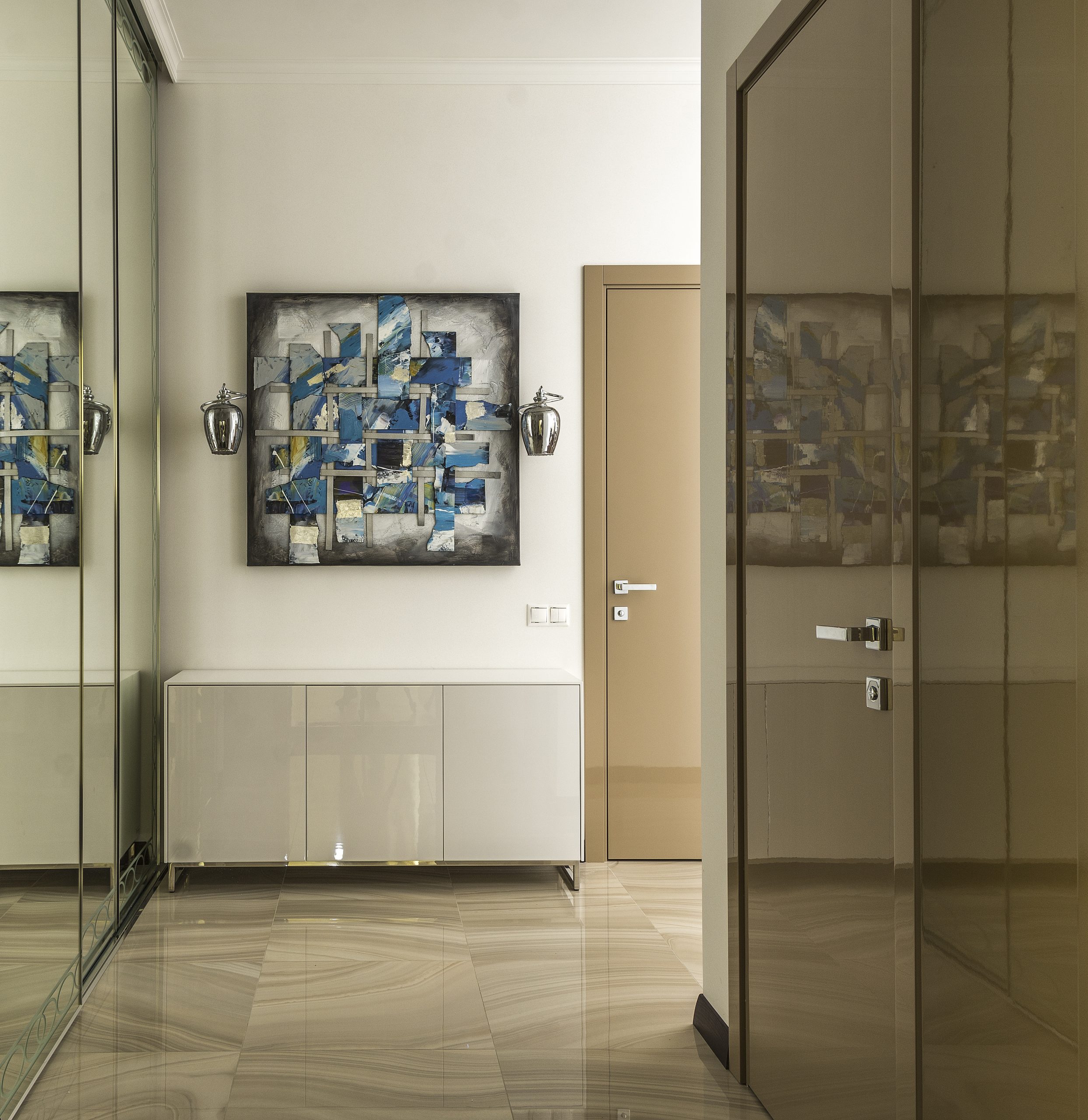 Empty spacious corridor with big wardrobe with mirror doors and abstract picture on wall