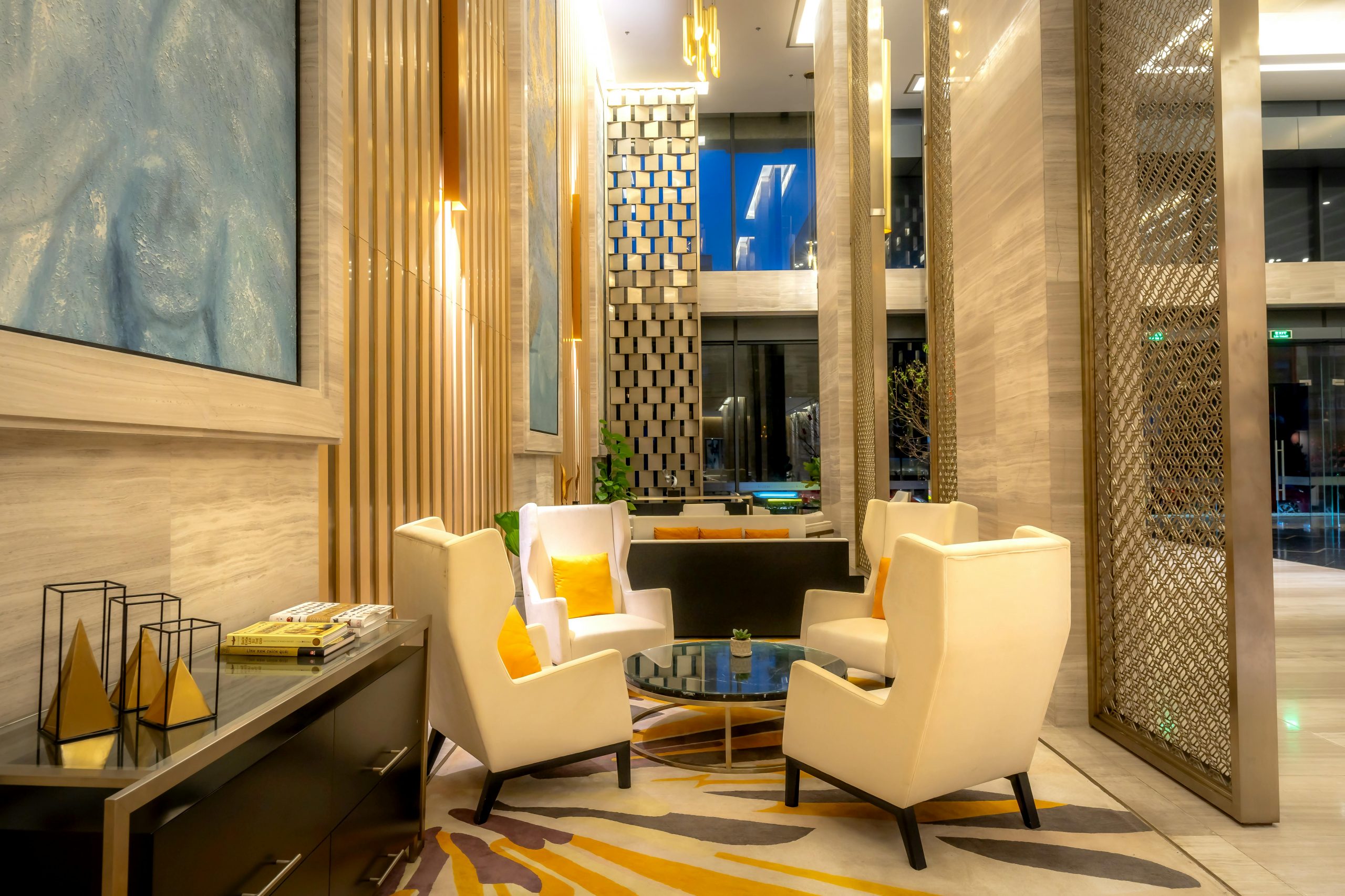 Luxurious hotel lobby featuring comfortable armchairs and sophisticated decor.