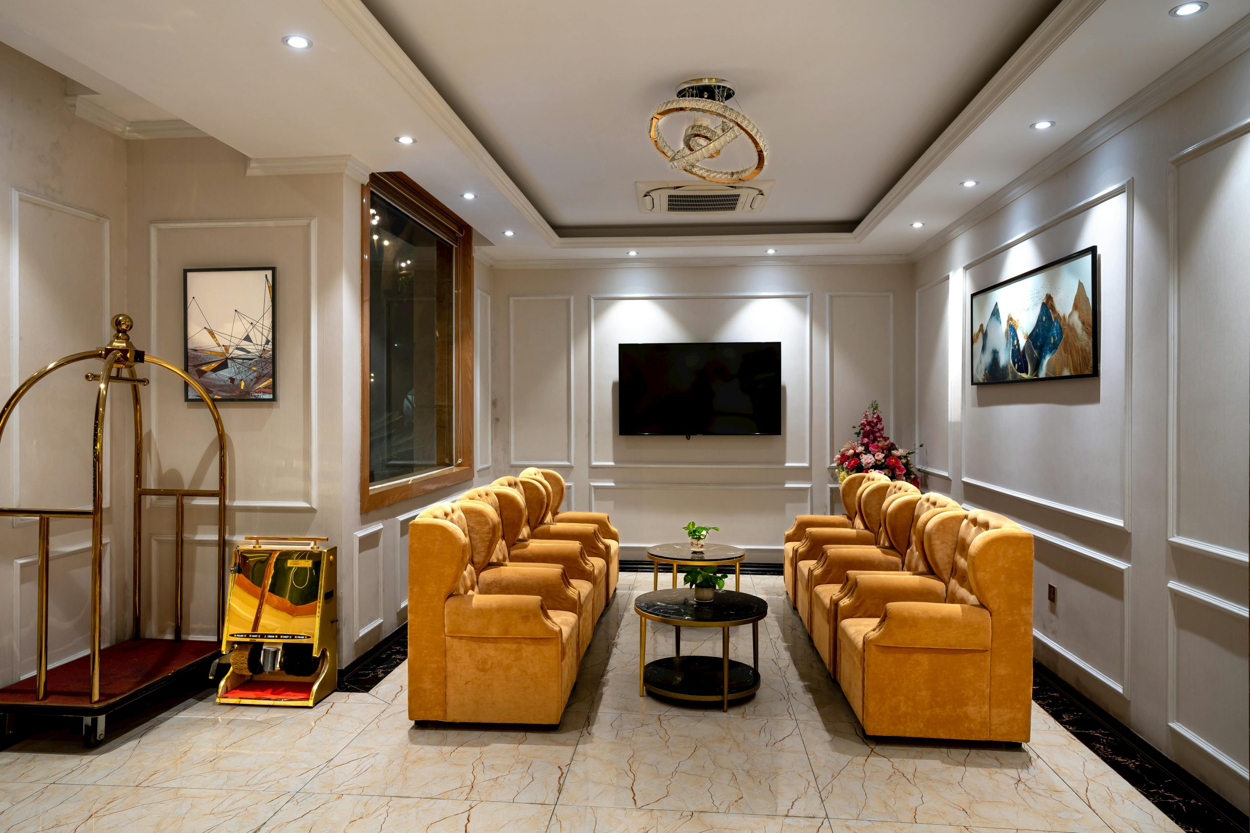 Luxurious hotel lobby featuring stylish armchairs, lighting, and decor.