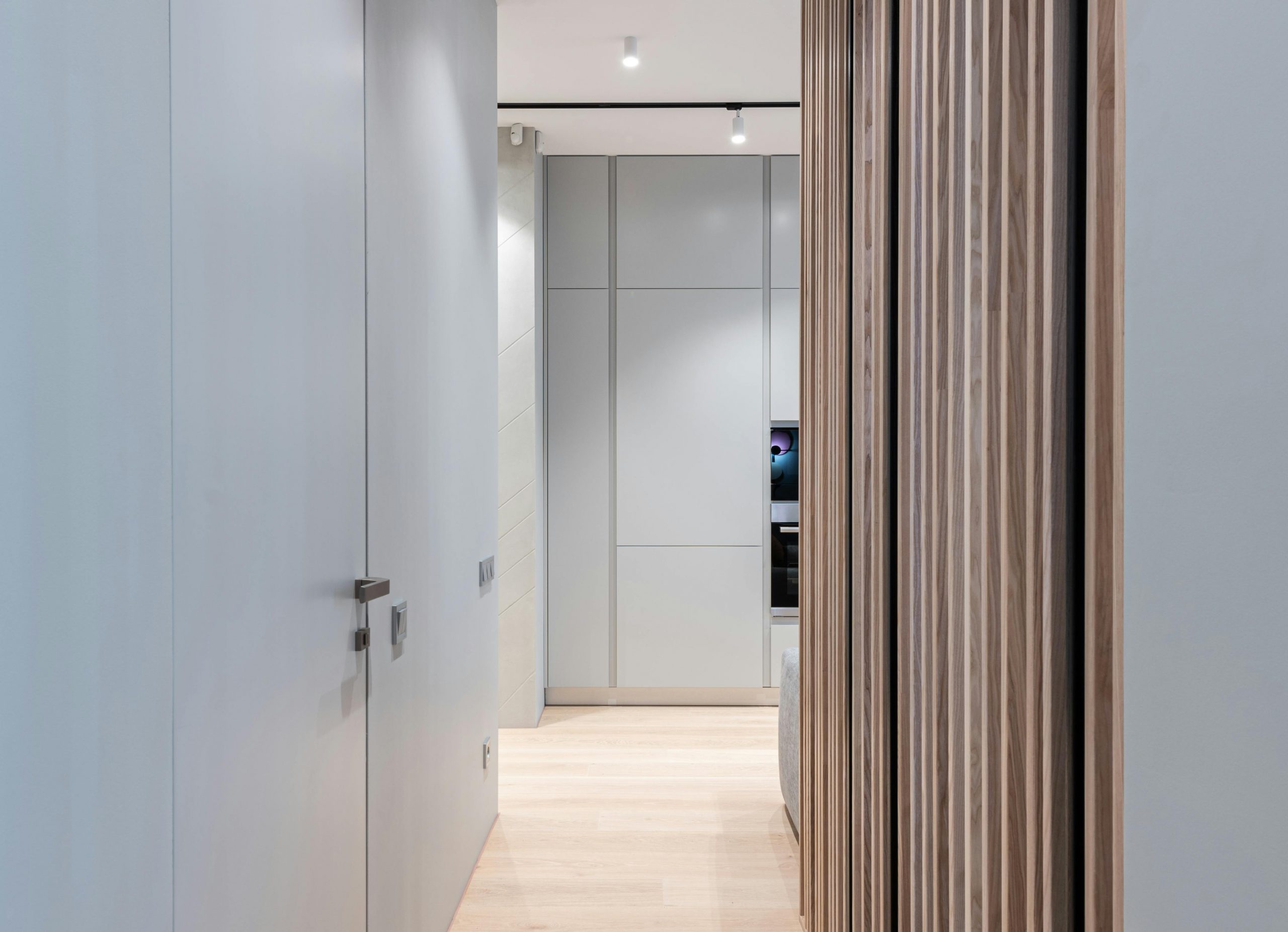 Modern empty hallway interior with door and walls leading to light spacious room