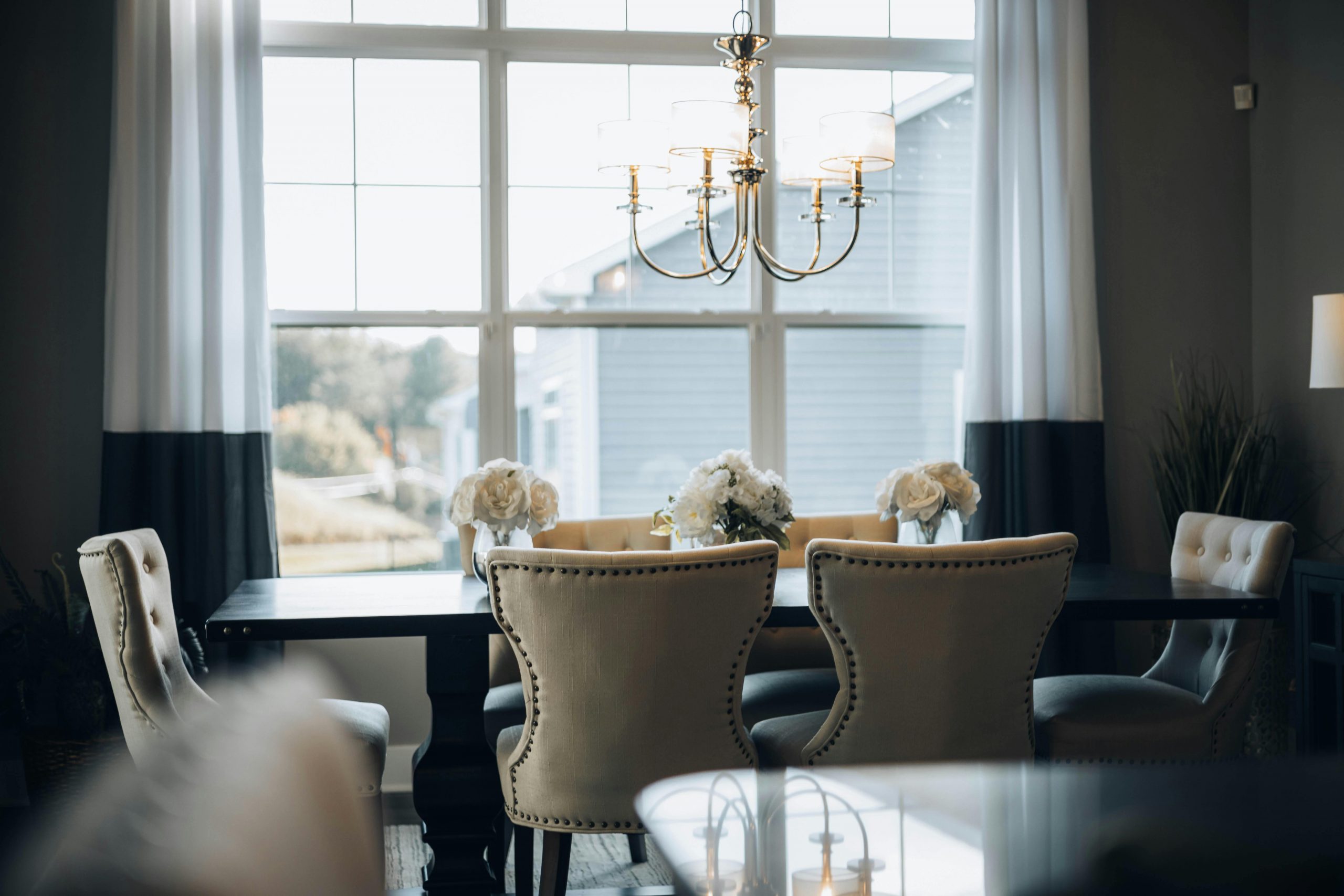 Sophisticated dining room interior featuring a classic chandelier and elegant decor, perfect for home design inspiration.