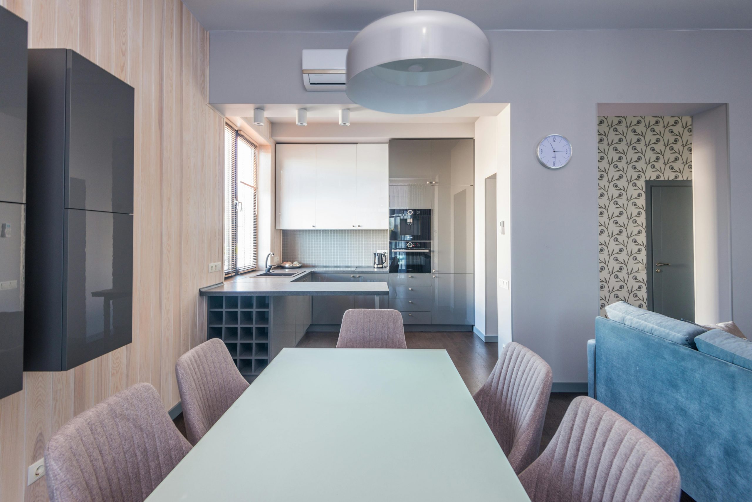 Stylish and contemporary kitchen with dining area and chic furniture setup.