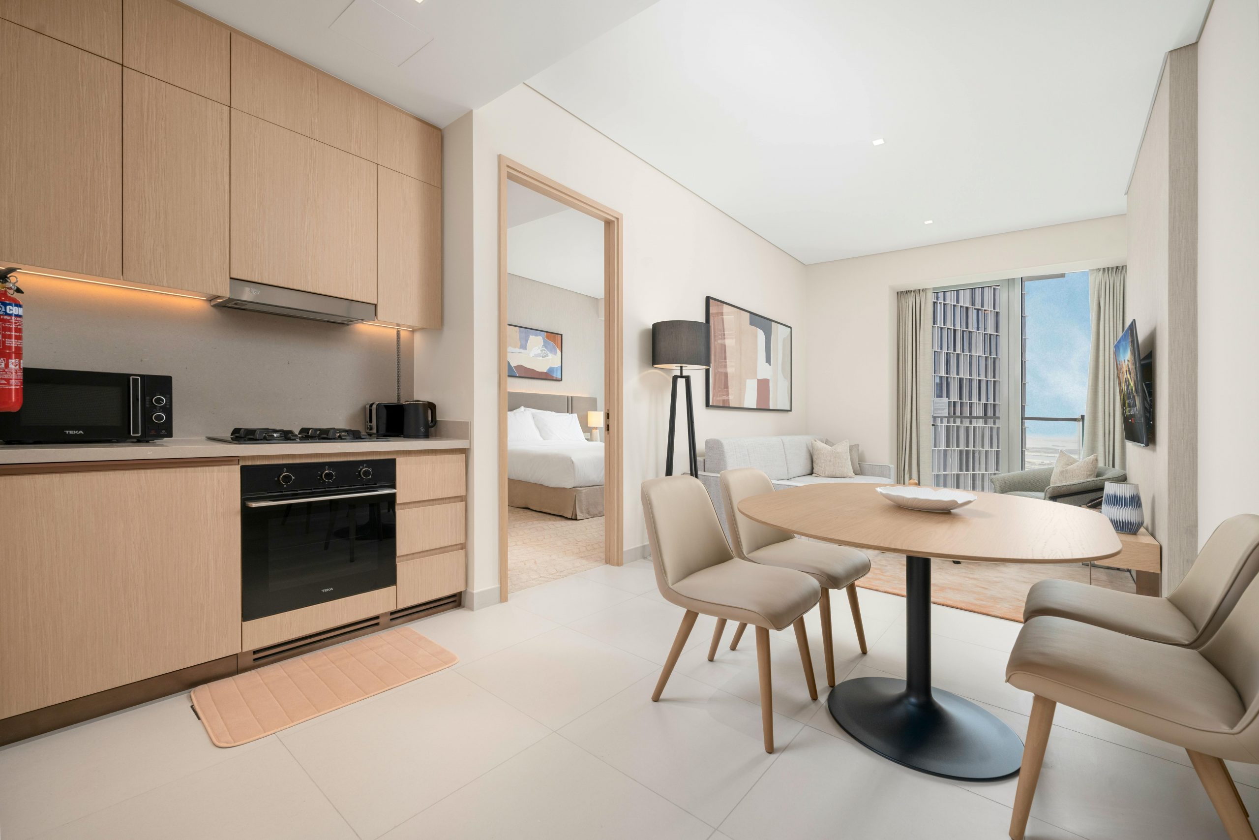 Stylish living area with kitchen and dining setup in modern apartment.