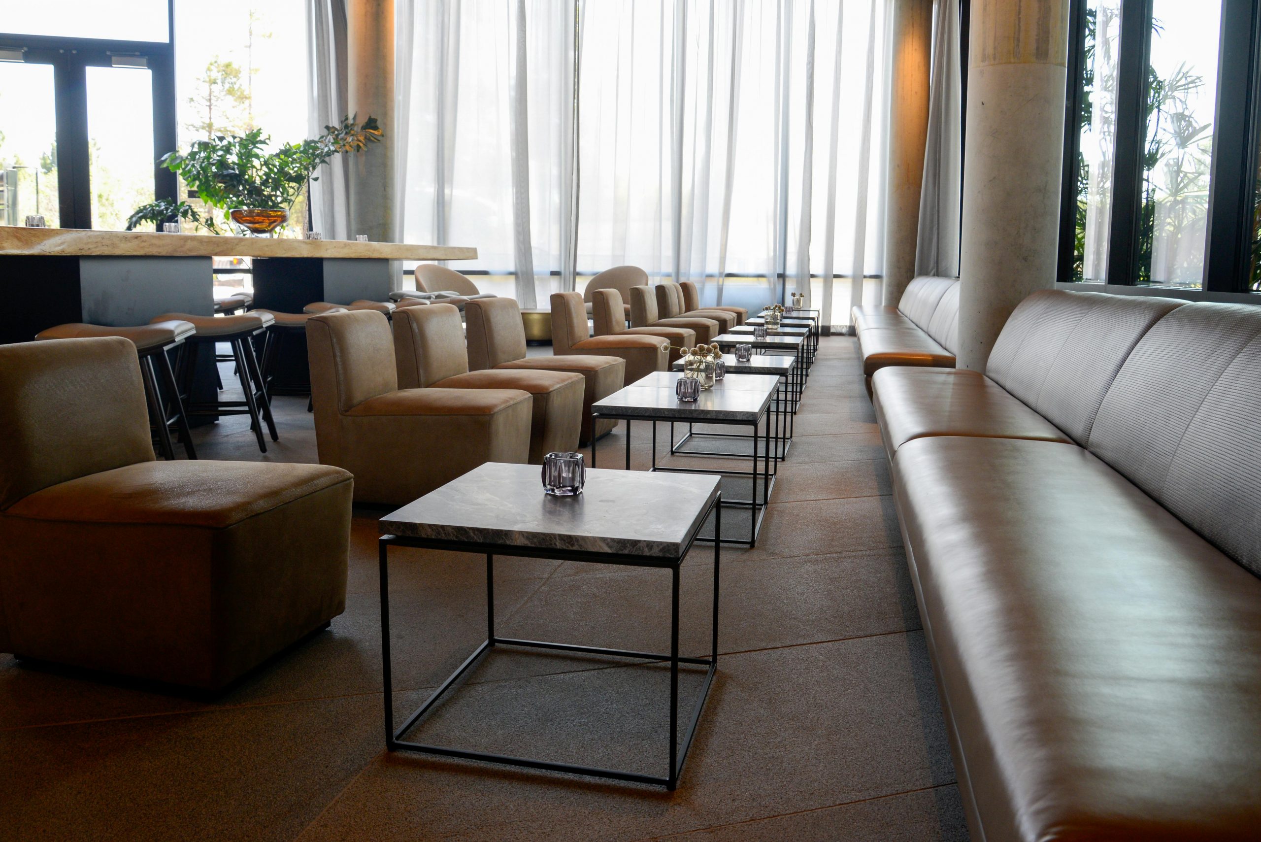 Stylish lounge area with modern furniture and natural lighting, ideal for luxury settings.