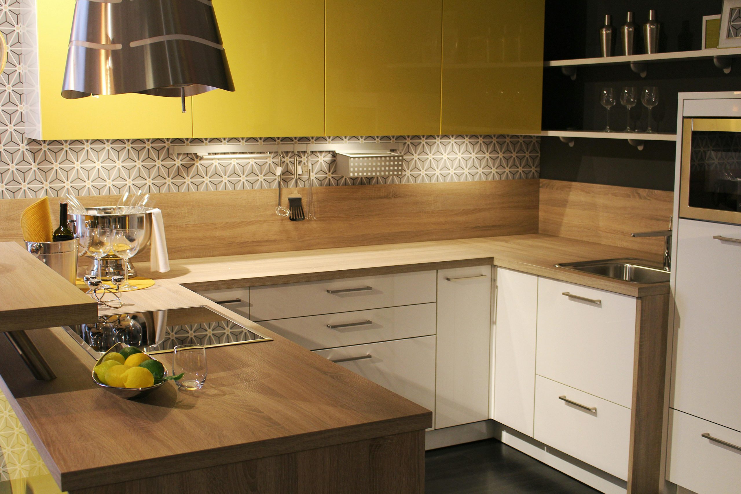 Stylish modern kitchen with yellow cabinets, wood countertops, and sleek appliances.