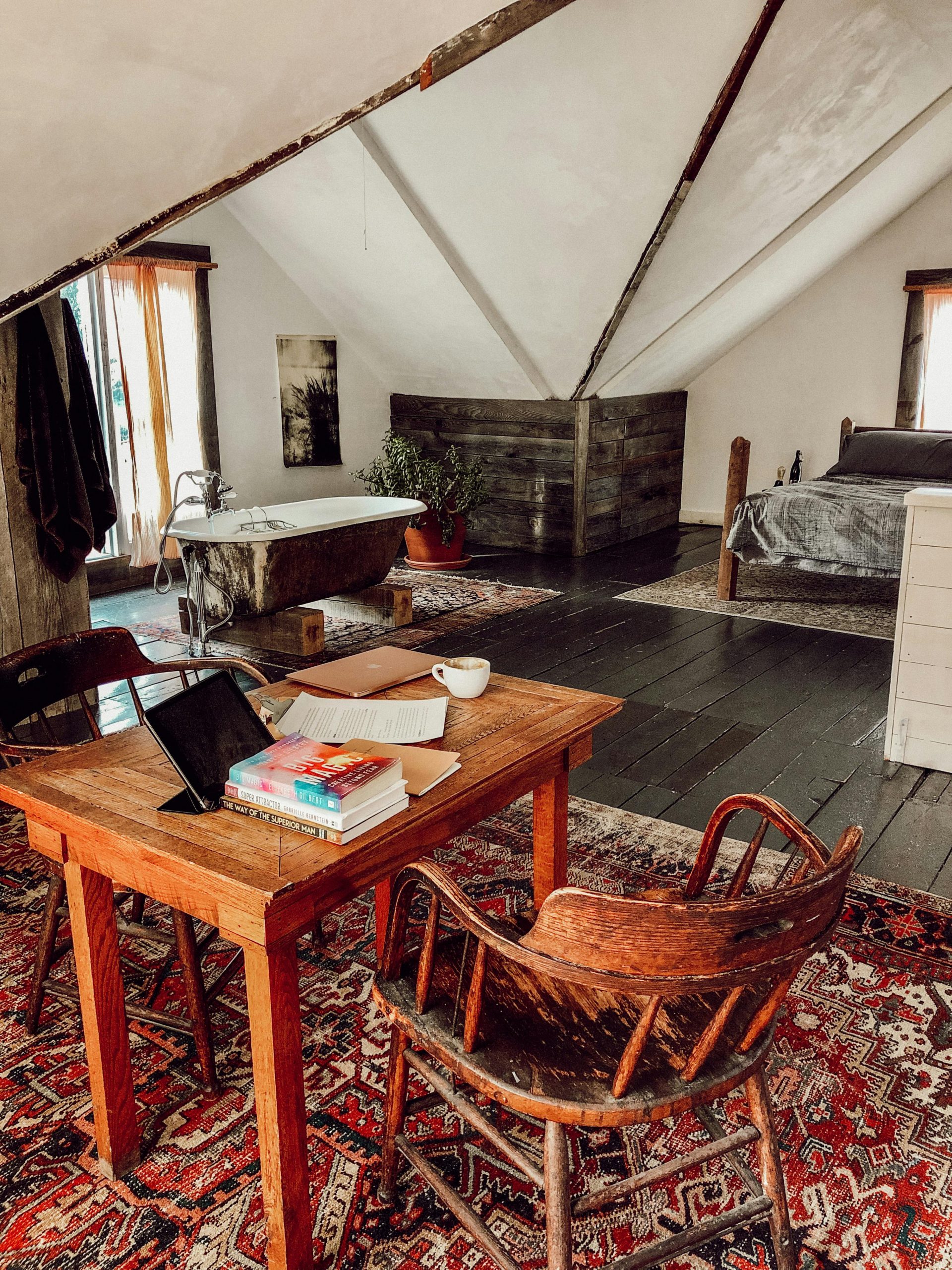 Warm and inviting attic room with rustic furniture, antique accents, and natural light.