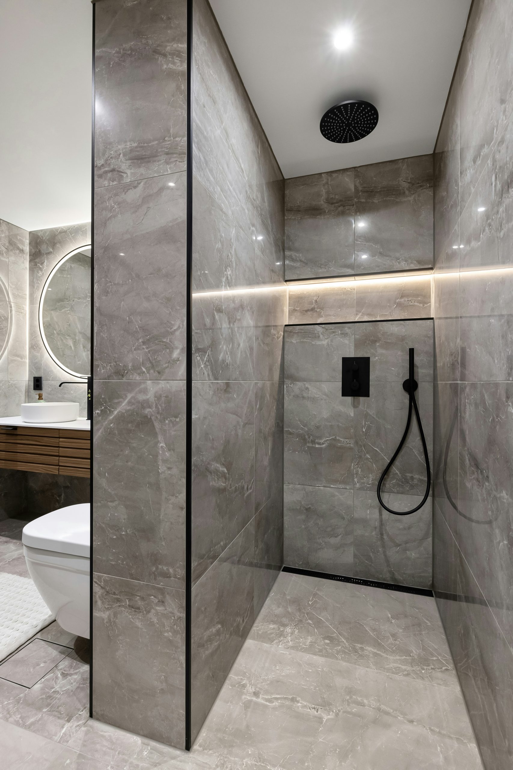A bathroom with a toilet and a shower