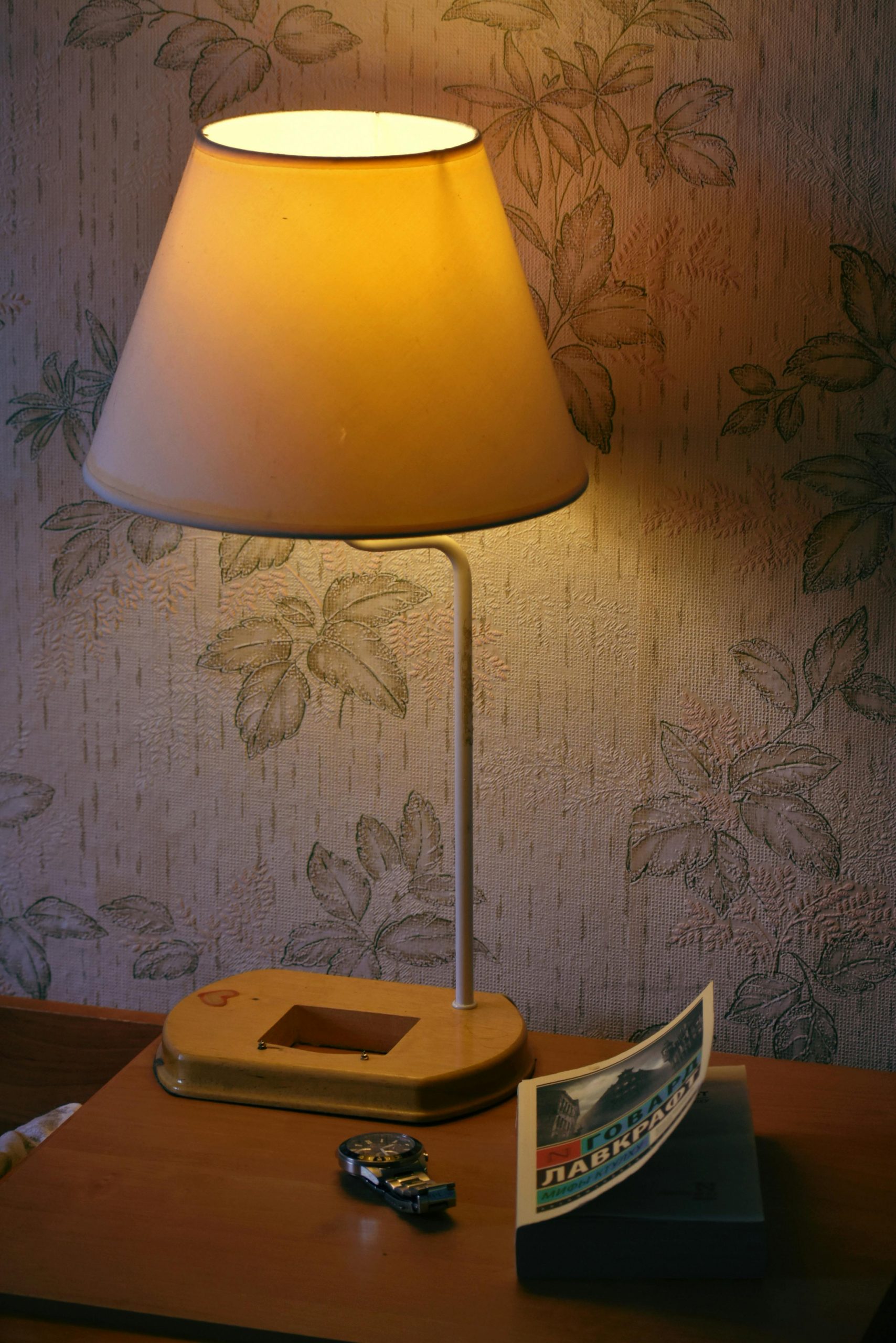 A cozy bedside setup with a retro lamp and books, perfect for home decor inspiration.