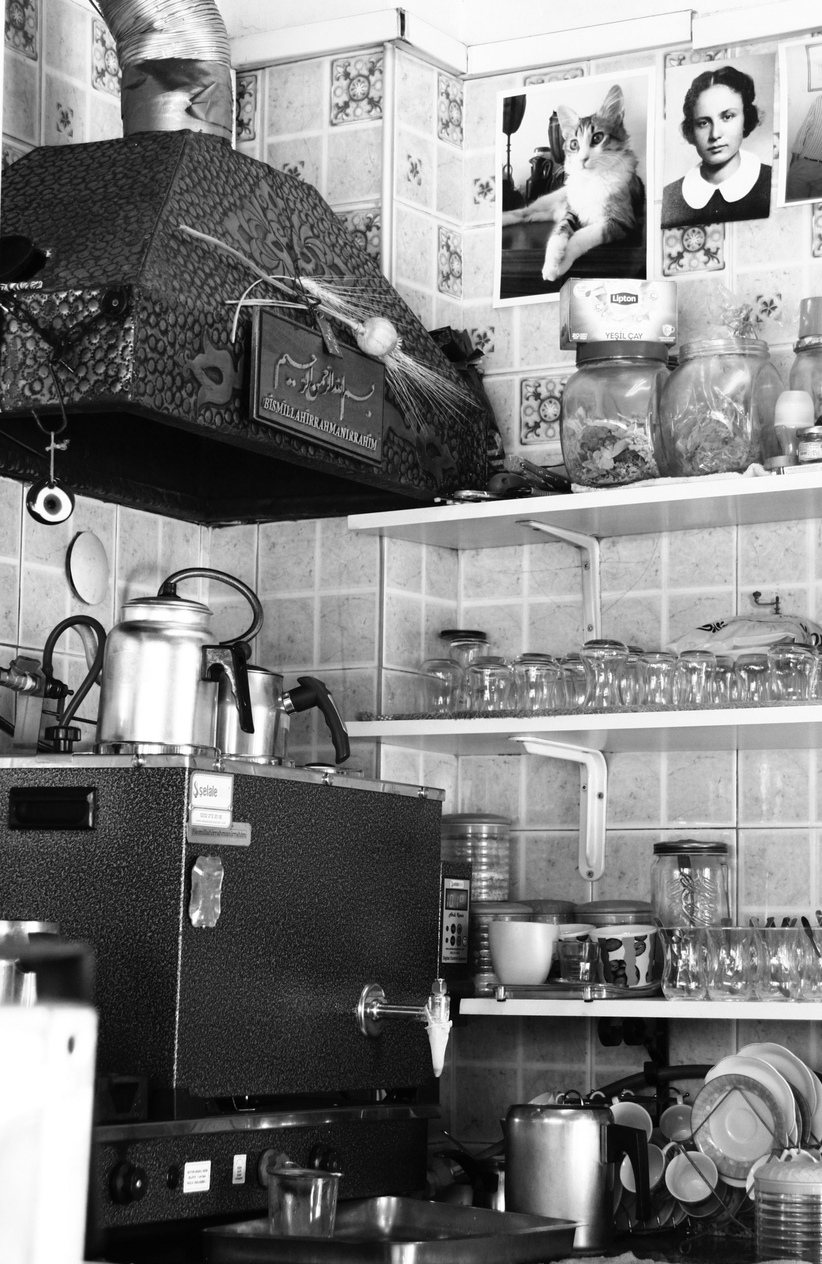 A cozy black and white kitchen scene with vintage decor, kitchenware, and shelves.