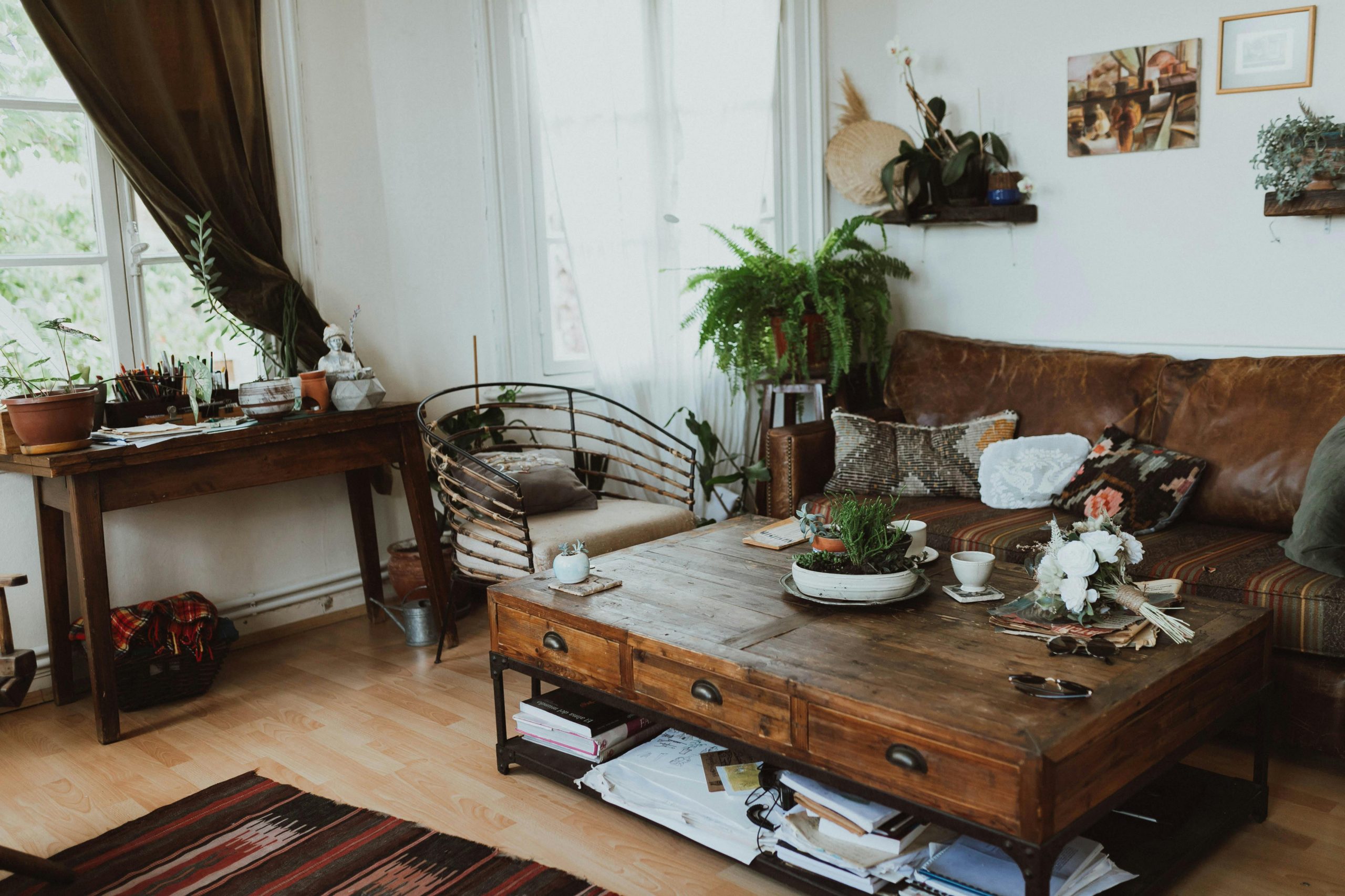 A cozy living room with vintage furniture, rustic decor, and indoor plants creating a warm ambiance.