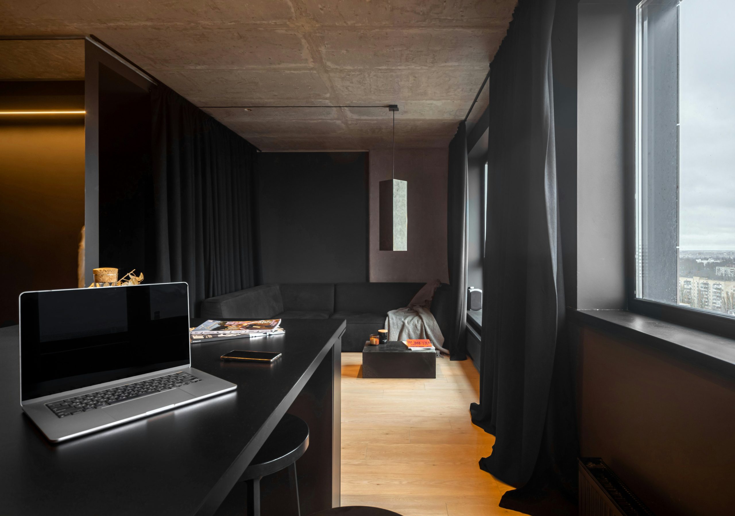 A modern, minimalist apartment with dark interior.