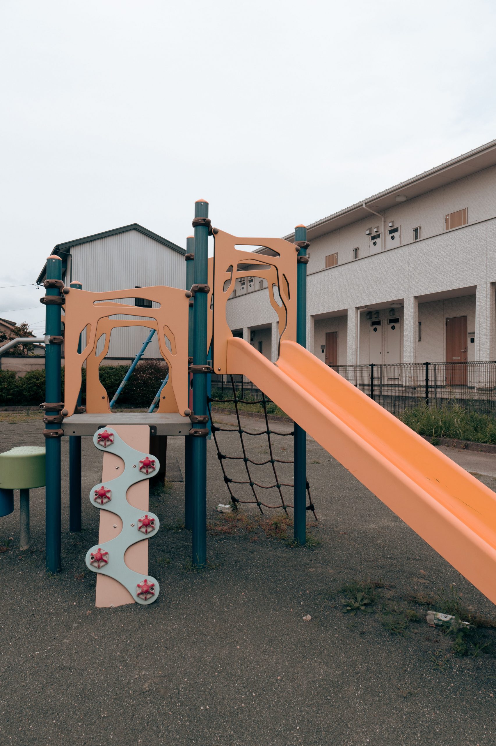 A vibrant playground in Toyohashi, Japan featuring a slide and climbing equipment.