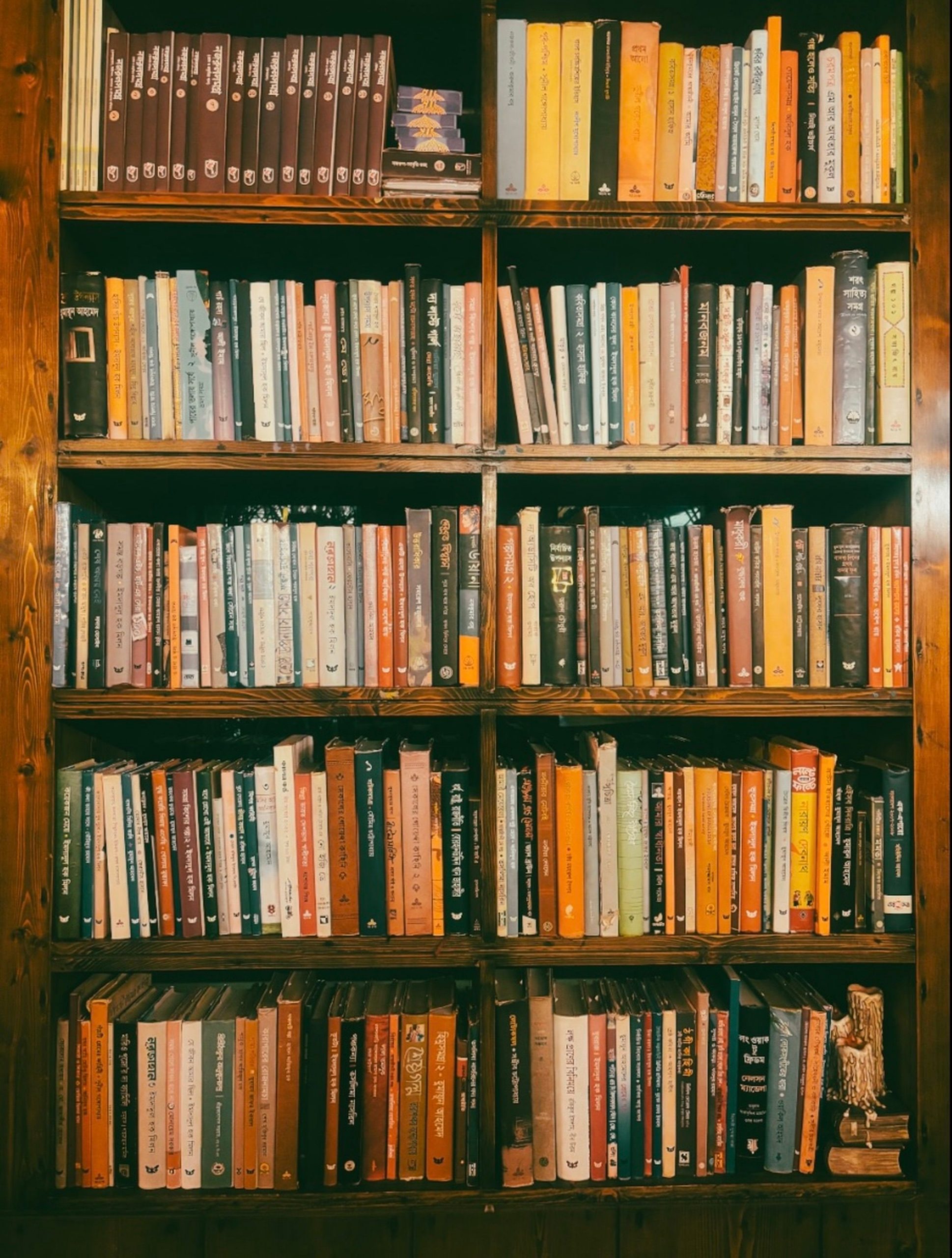 A warm-toned wooden bookshelf filled with a variety of books, inviting reading exploration.