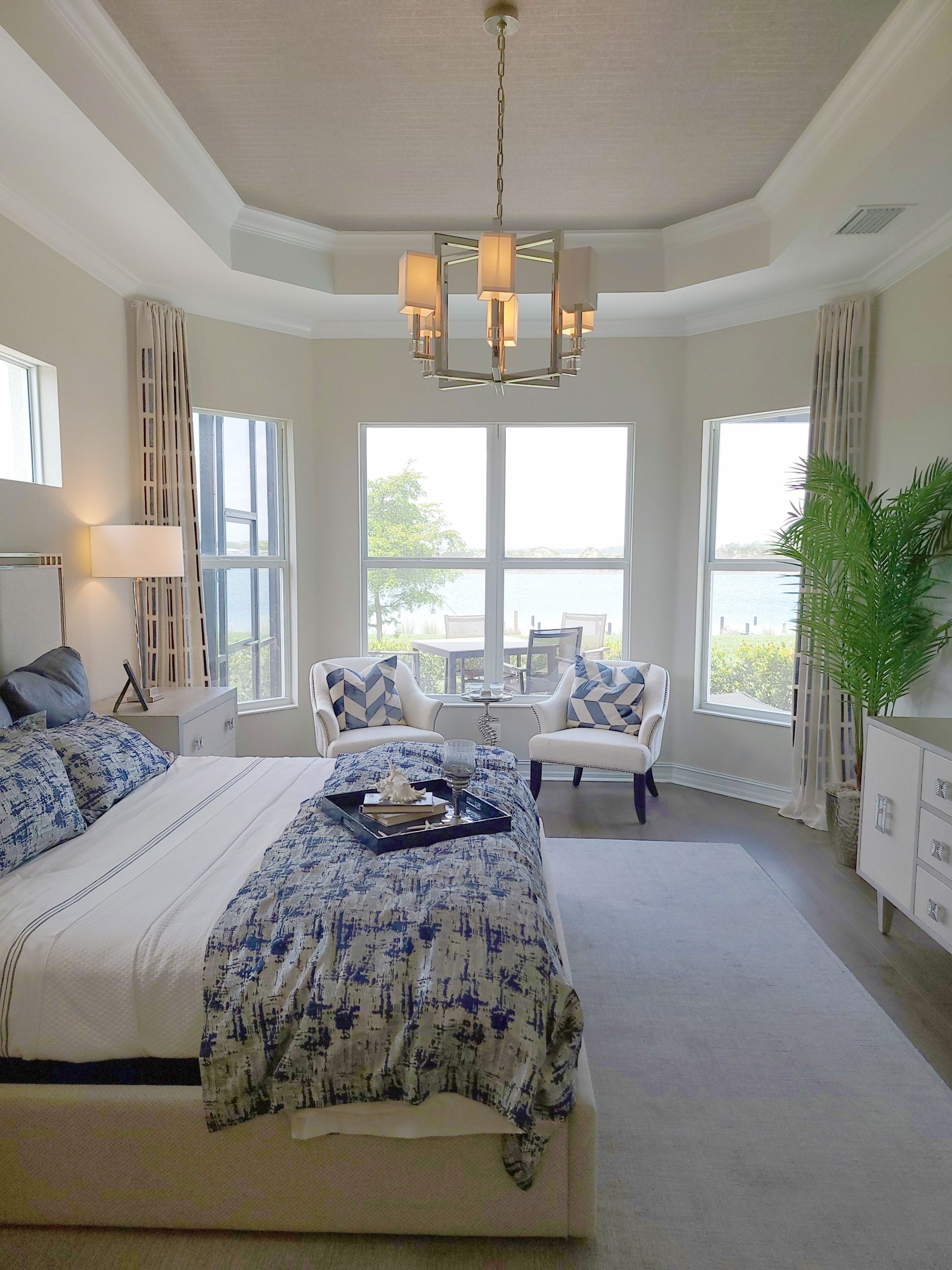 Bright and airy bedroom featuring elegant decor with coastal views, a perfect show home setup.