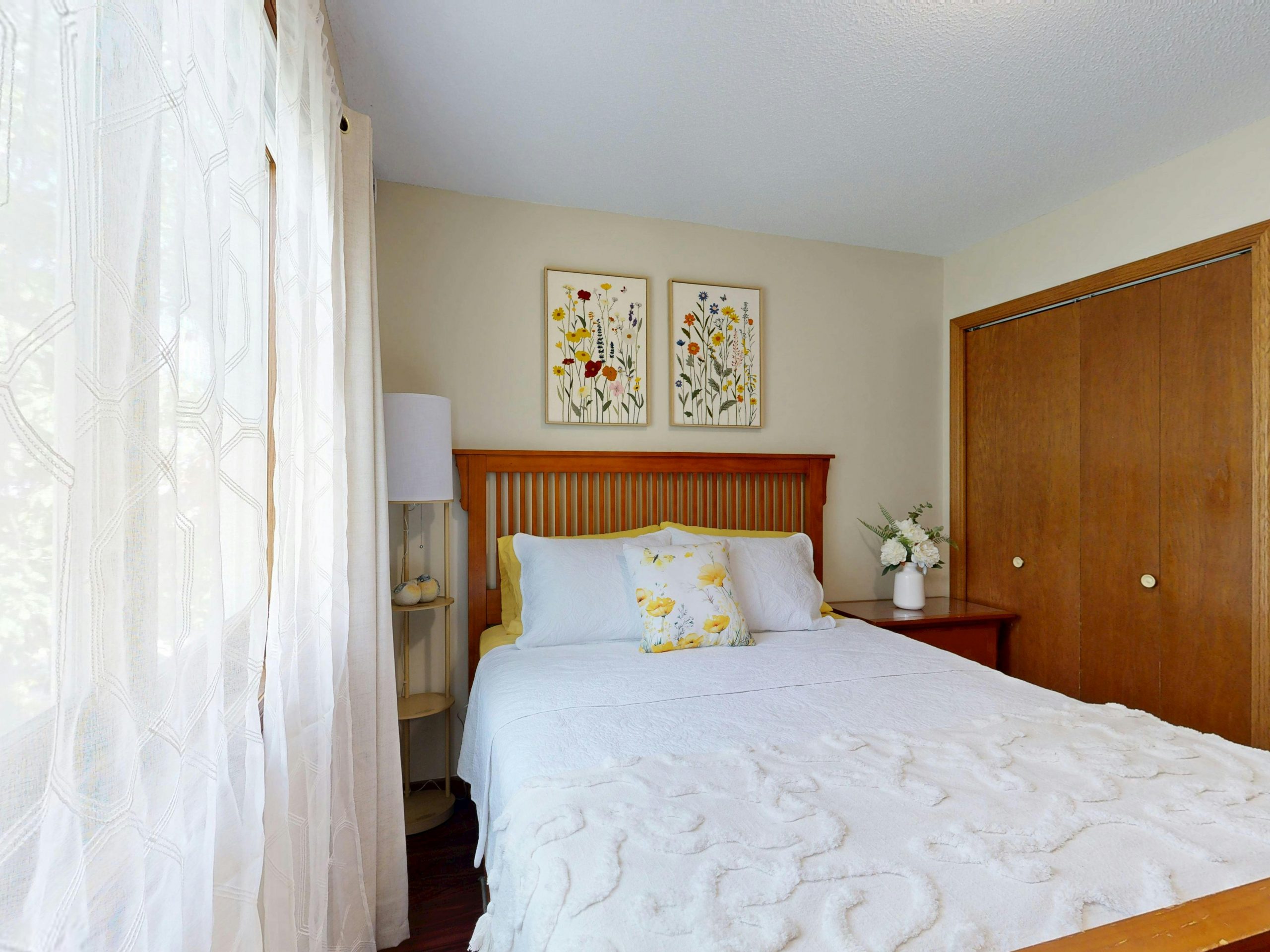 Bright bedroom with floral decor and wooden elements. Perfect for home decor inspiration.