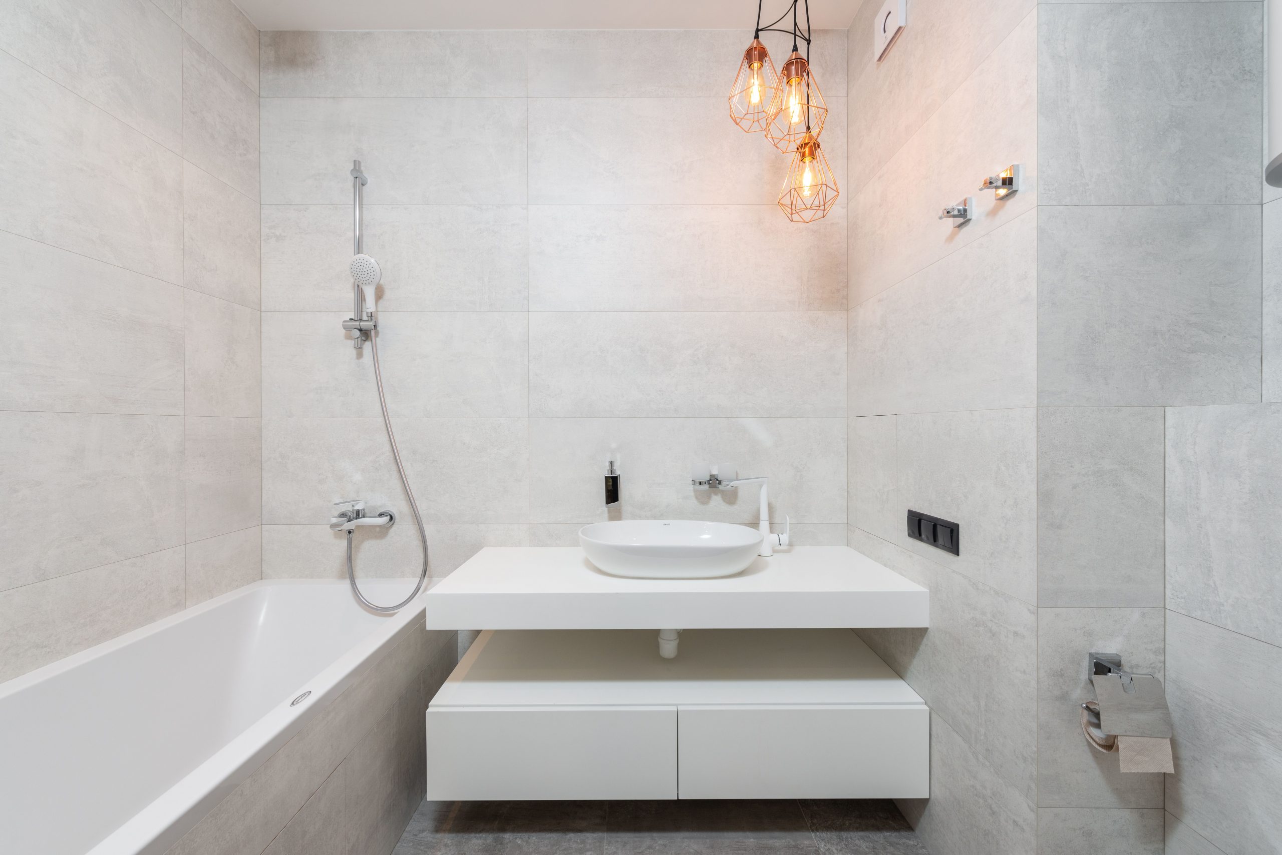 Bright, modern minimalist bathroom with marble tiles and elegant vanity.