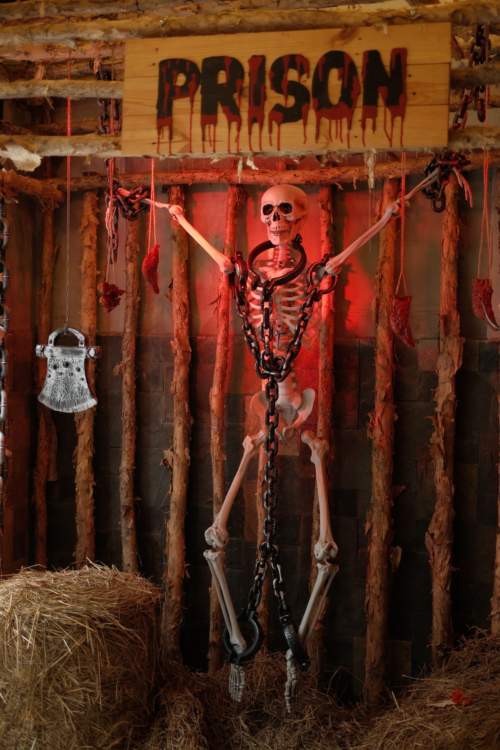 Chilling Halloween display with a skeleton chained in a creepy prison setting. Perfect for festive and spooky themes.
