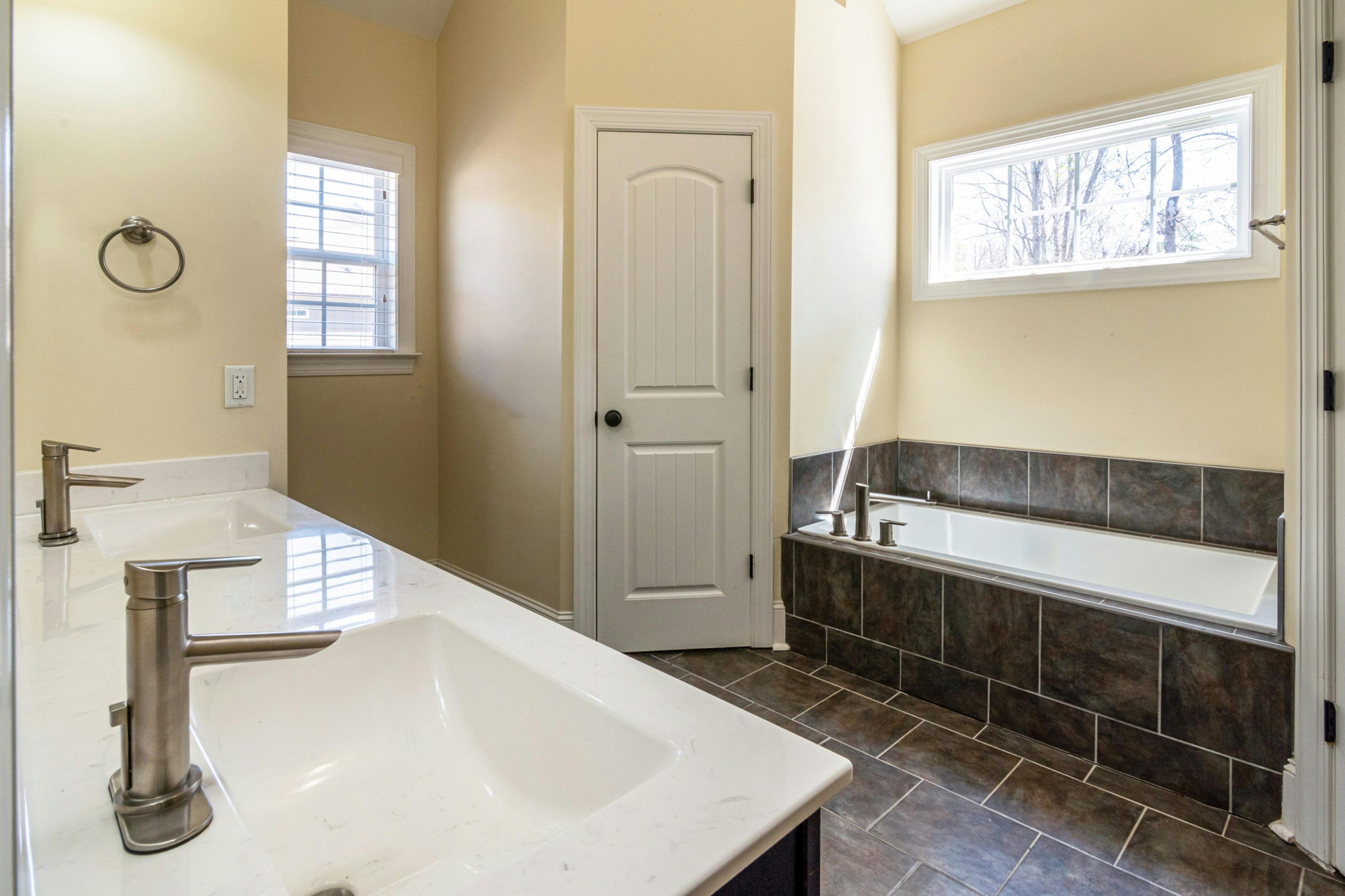 Contemporary bathroom featuring double sinks and a bathtub, perfect for relaxation.
