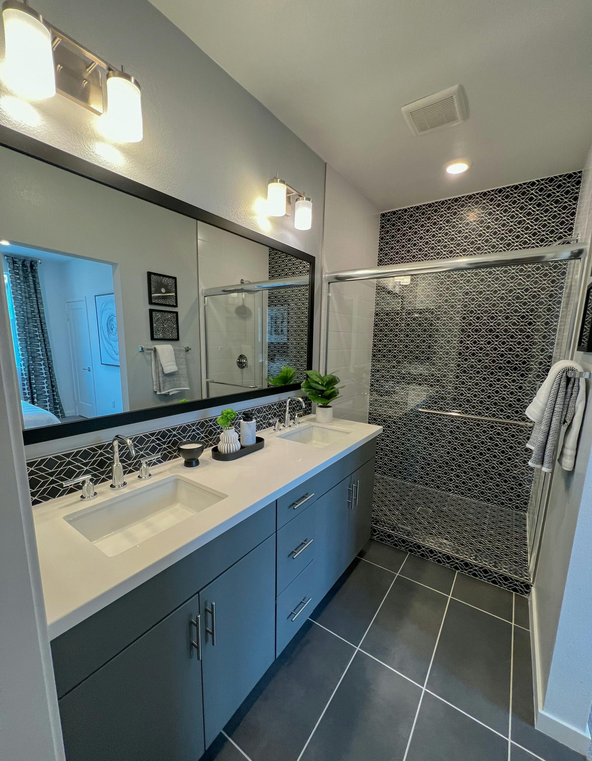 Contemporary bathroom showcasing sleek design with sink and shower area.