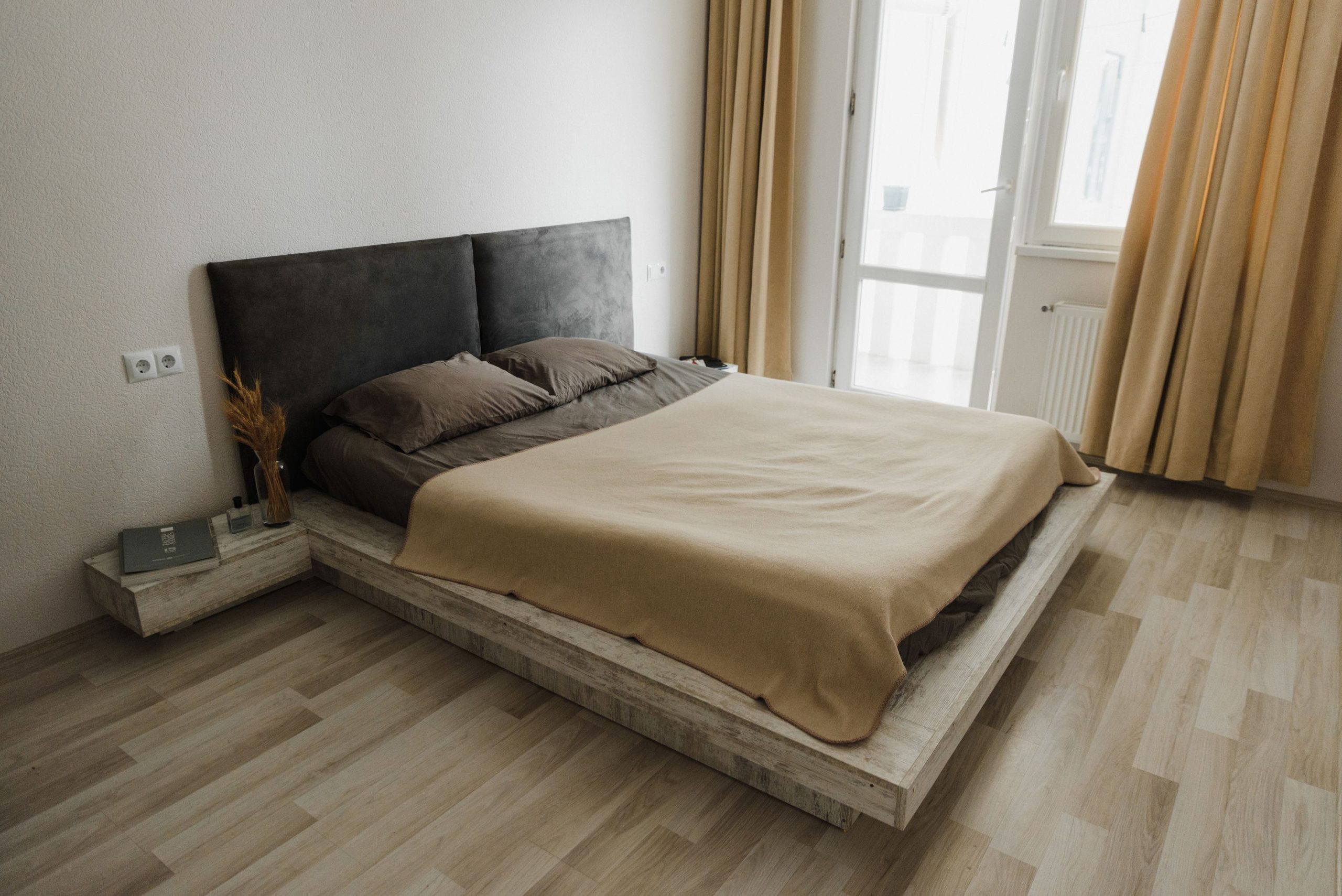 Cozy minimalist bedroom with neutral tones and natural light.