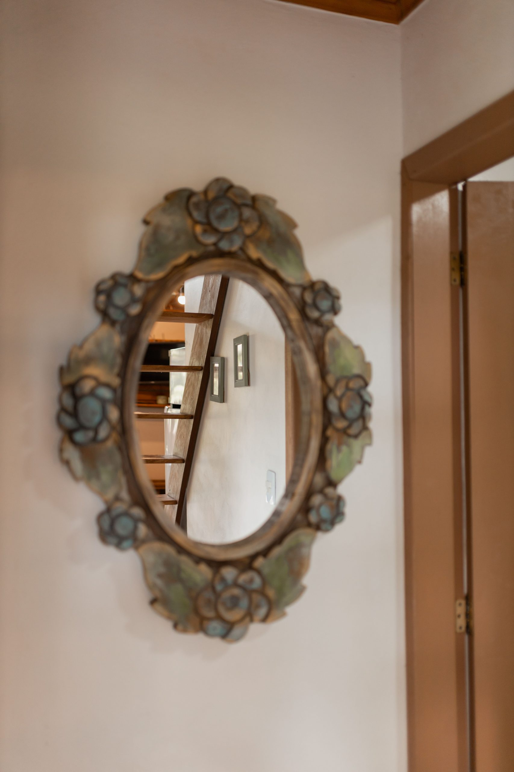 Decorative floral mirror reflects a warm and inviting home interior.