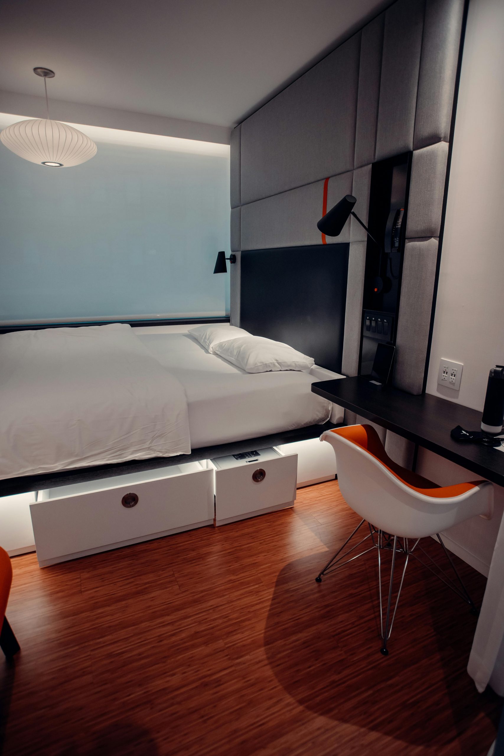 Discover a cozy and chic modern bedroom with elegant design and warm tones.