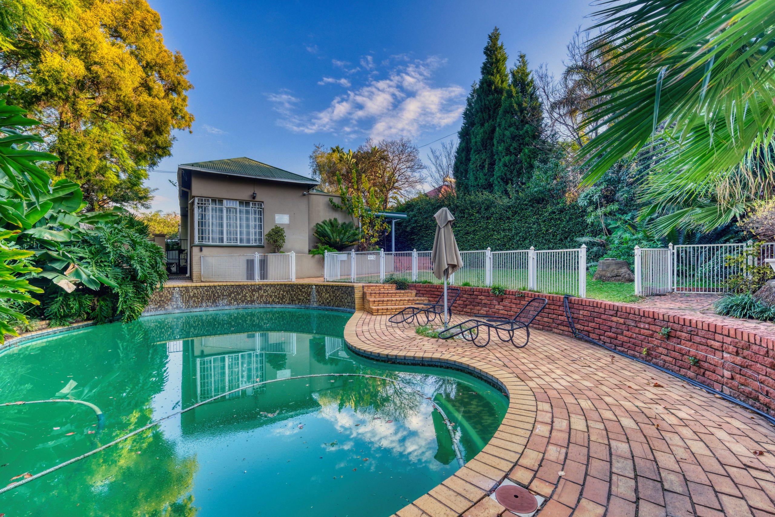 Elegant backyard pool area in Pretoria, South Africa. Perfect for home and real estate themes.