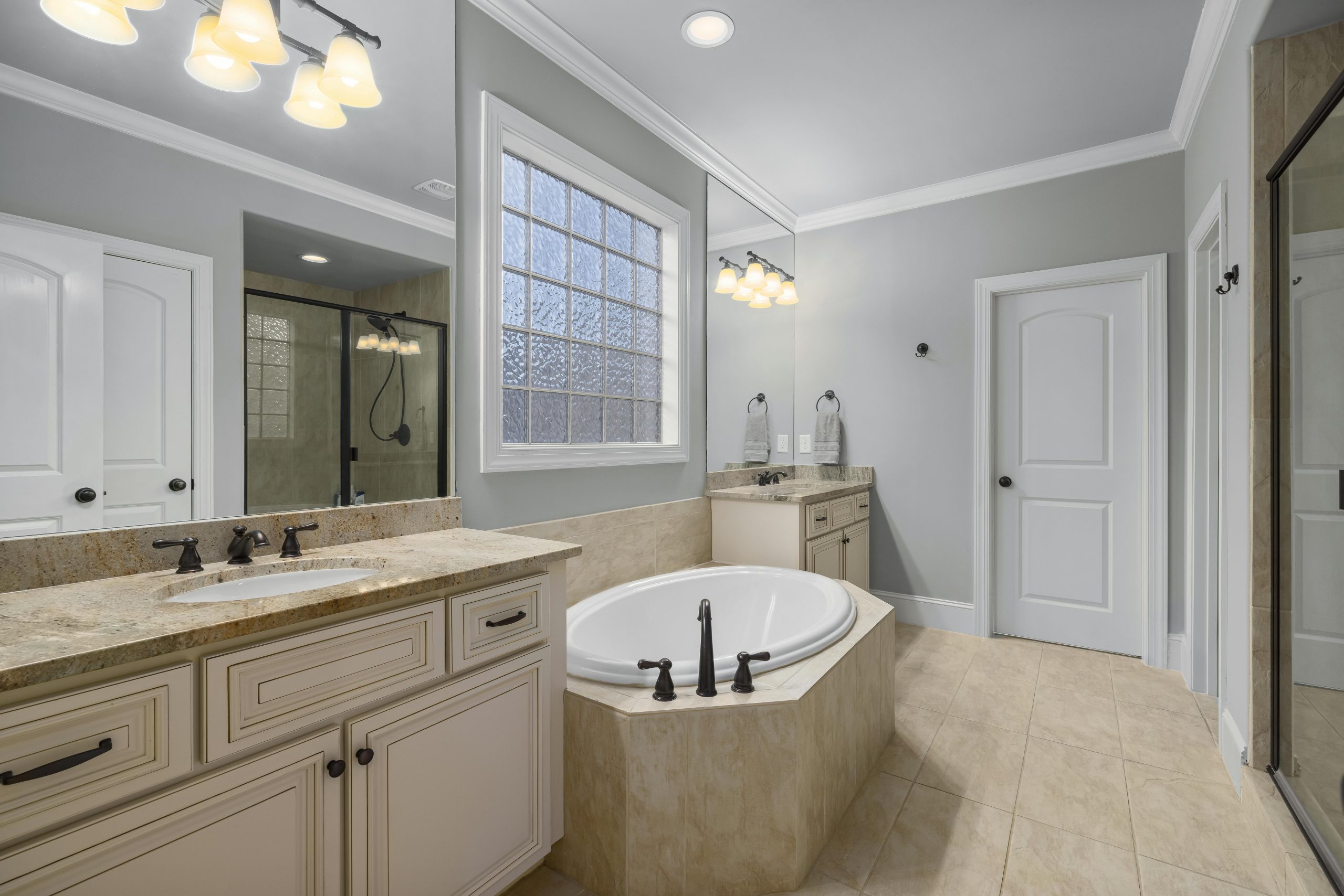 Elegant bathroom featuring a freestanding tub, stylish amenities, and neutral decor.